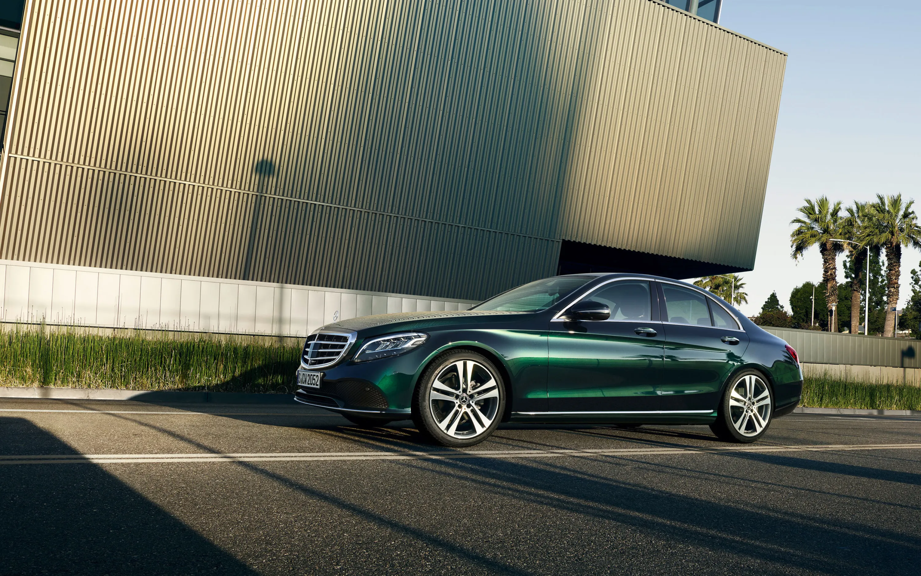 Green Mercedes Benz Sedan Parked Near Modern Architecture