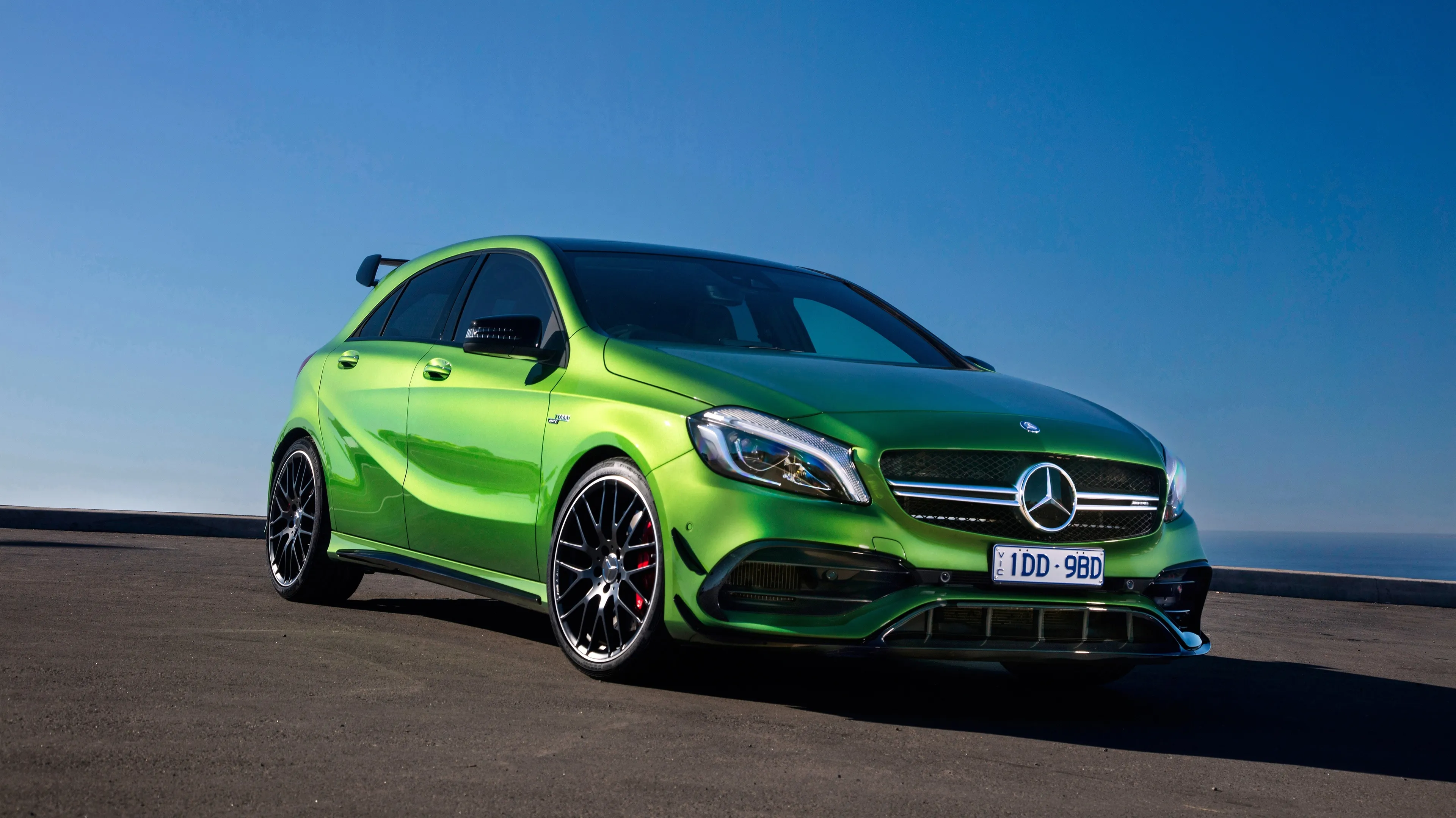 Green Mercedes Benz Sports Car Against Blue SkyWallpaper
