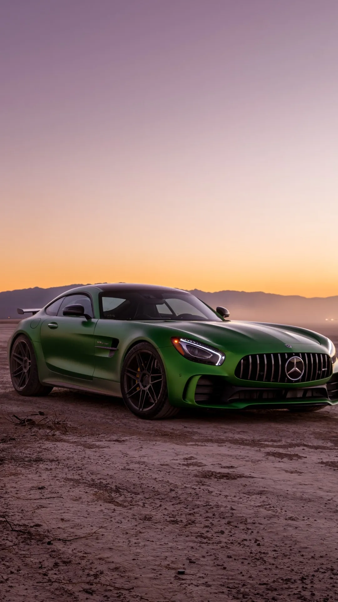 Green Mercedes Benz Sports Car on Dirt Road at Sunset