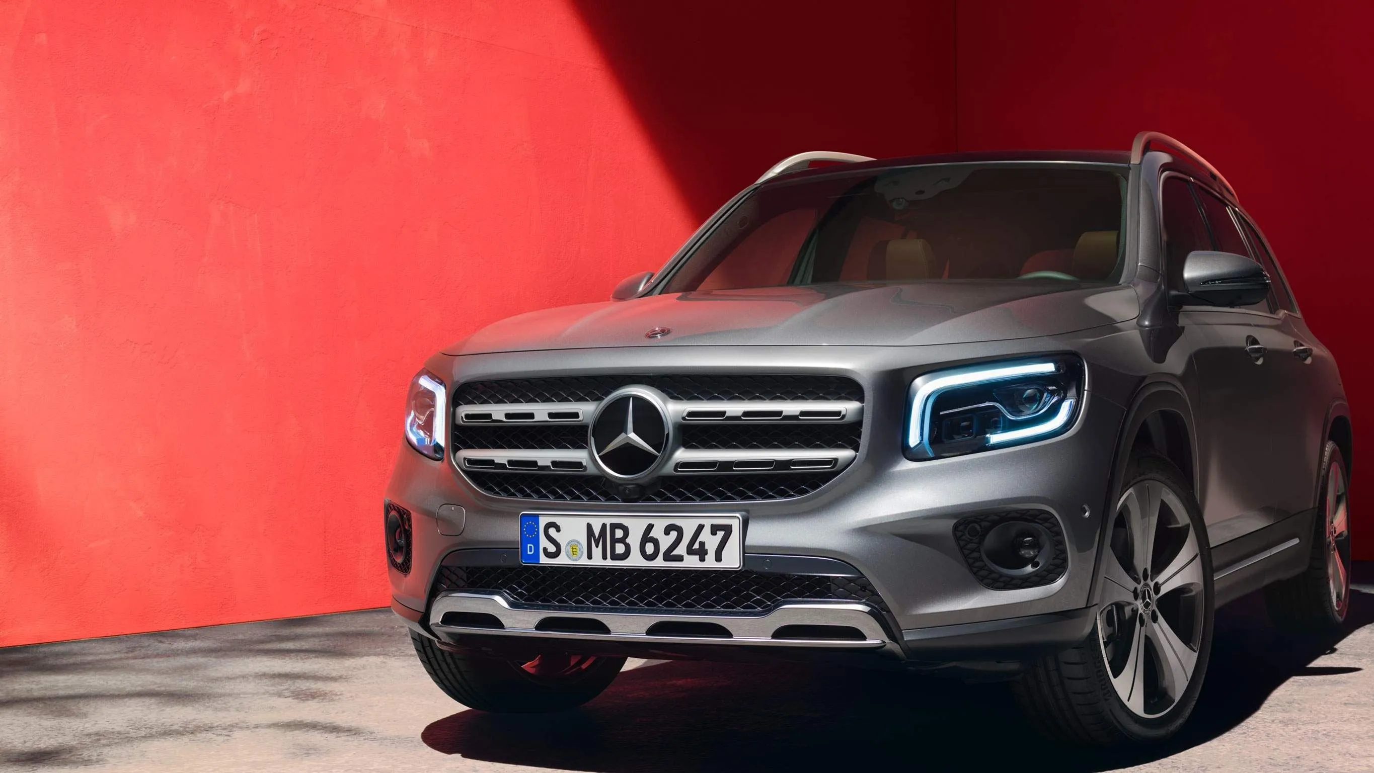 Grey Mercedes Benz Urban Style SUV against Red Wall
