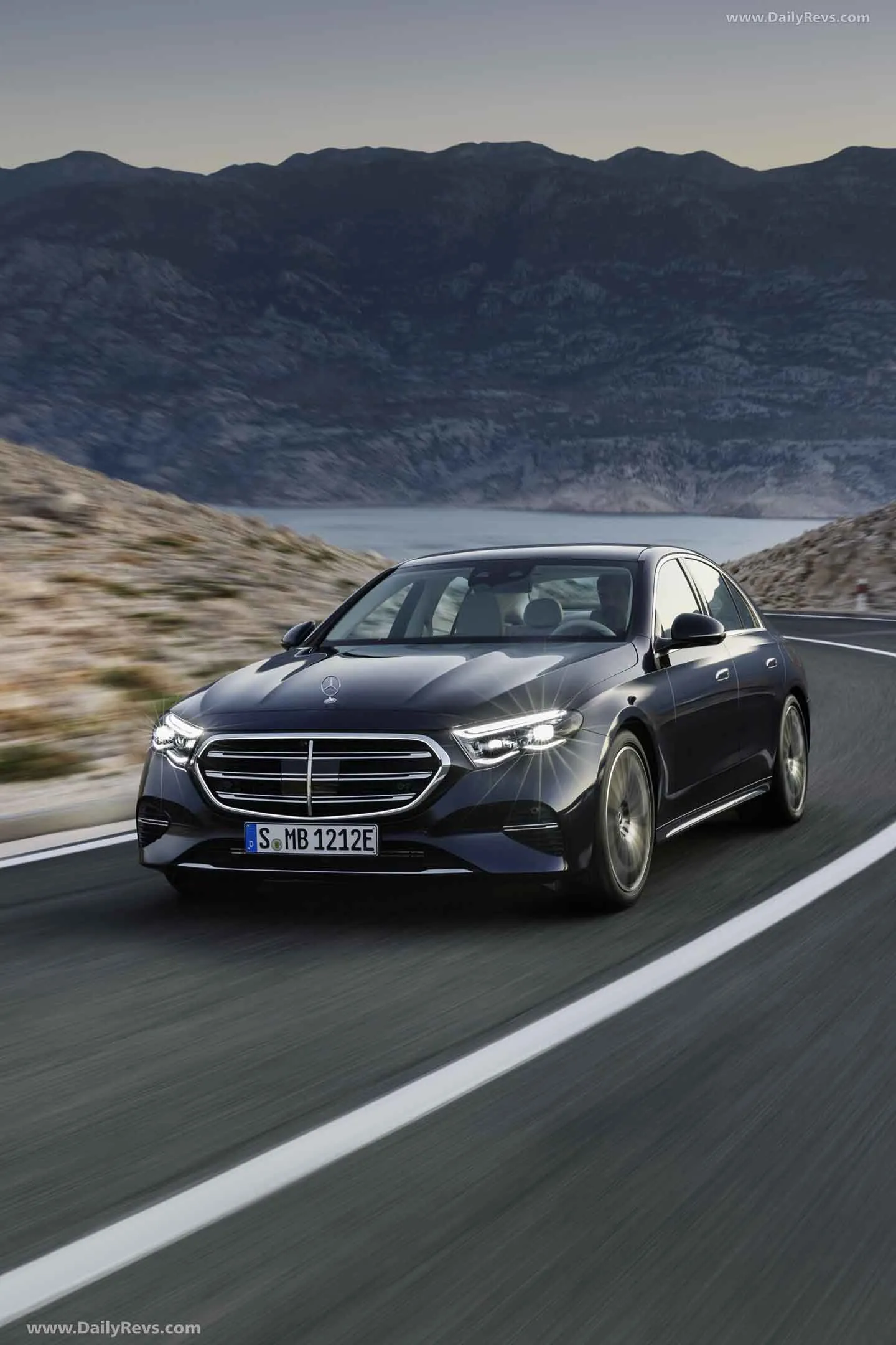 Grey Mercedes Driving Along Scenic Mountain Road Wallpaper