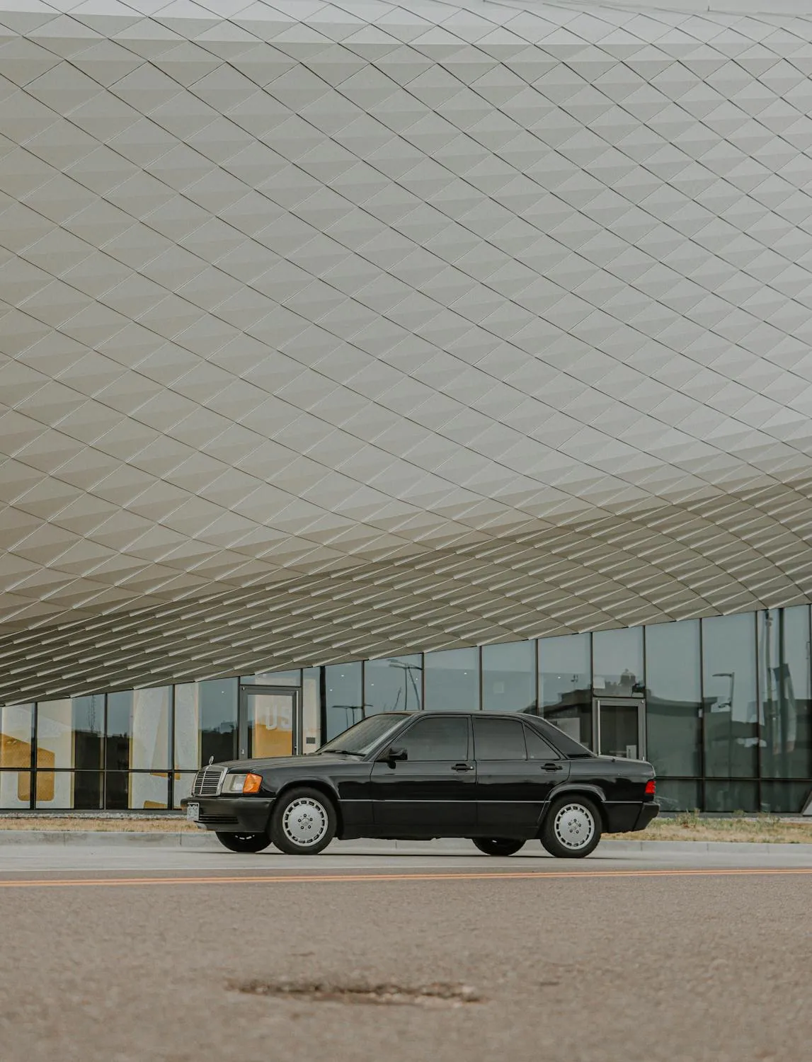 Grey Mercedes SUV Outside Contemporary Architecture