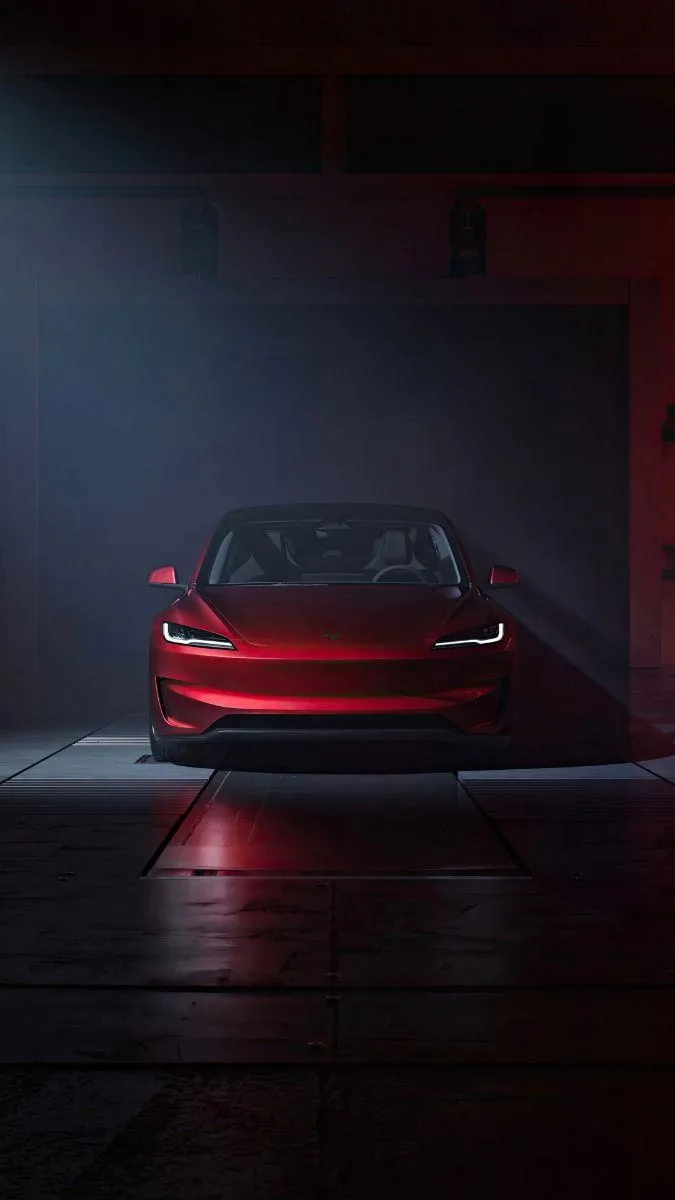 HD Image of Red Tesla Sedan under black granite