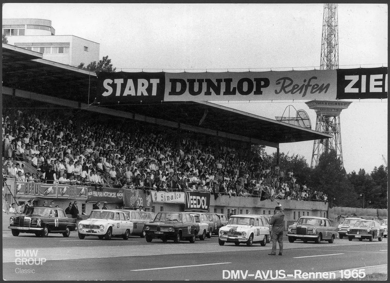 Historic Black and White Photo of Bmw Cars at a Race Event