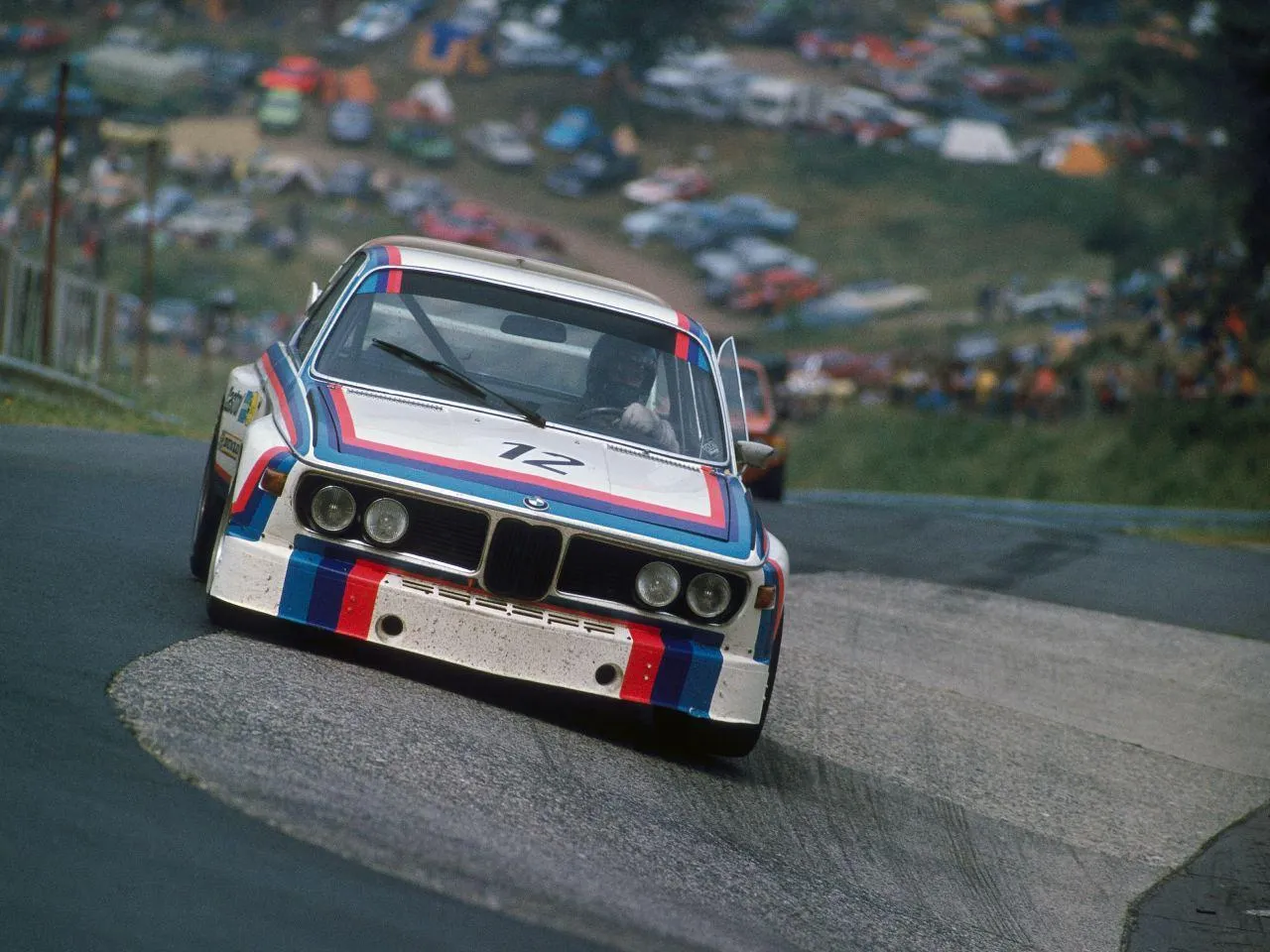Iconic Bmw Racing Car in Action on Mountain Roads Image