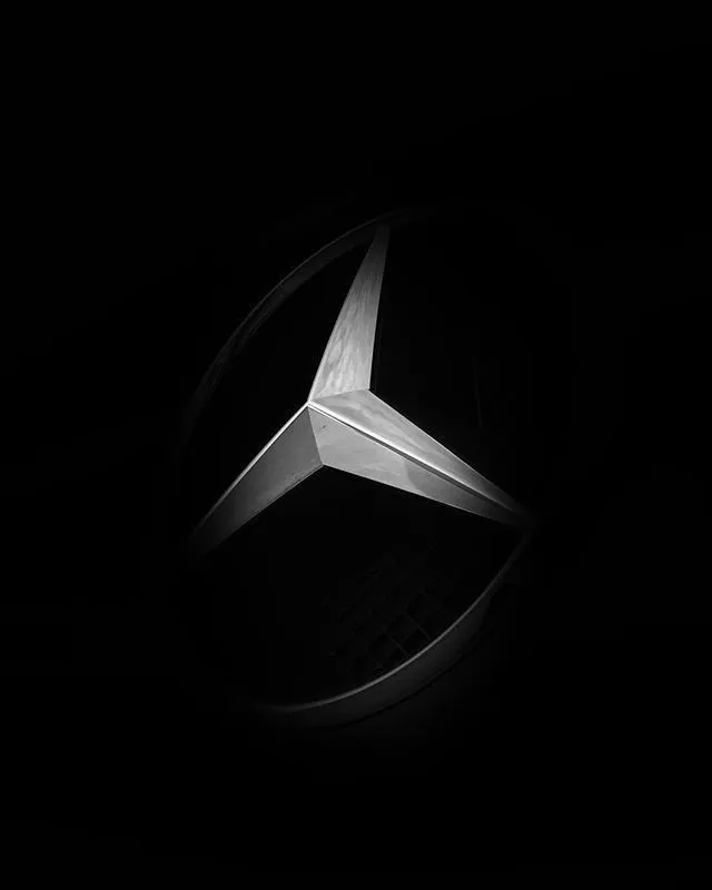 Illuminated Mercedes Logo Displayed in Glossy Black image