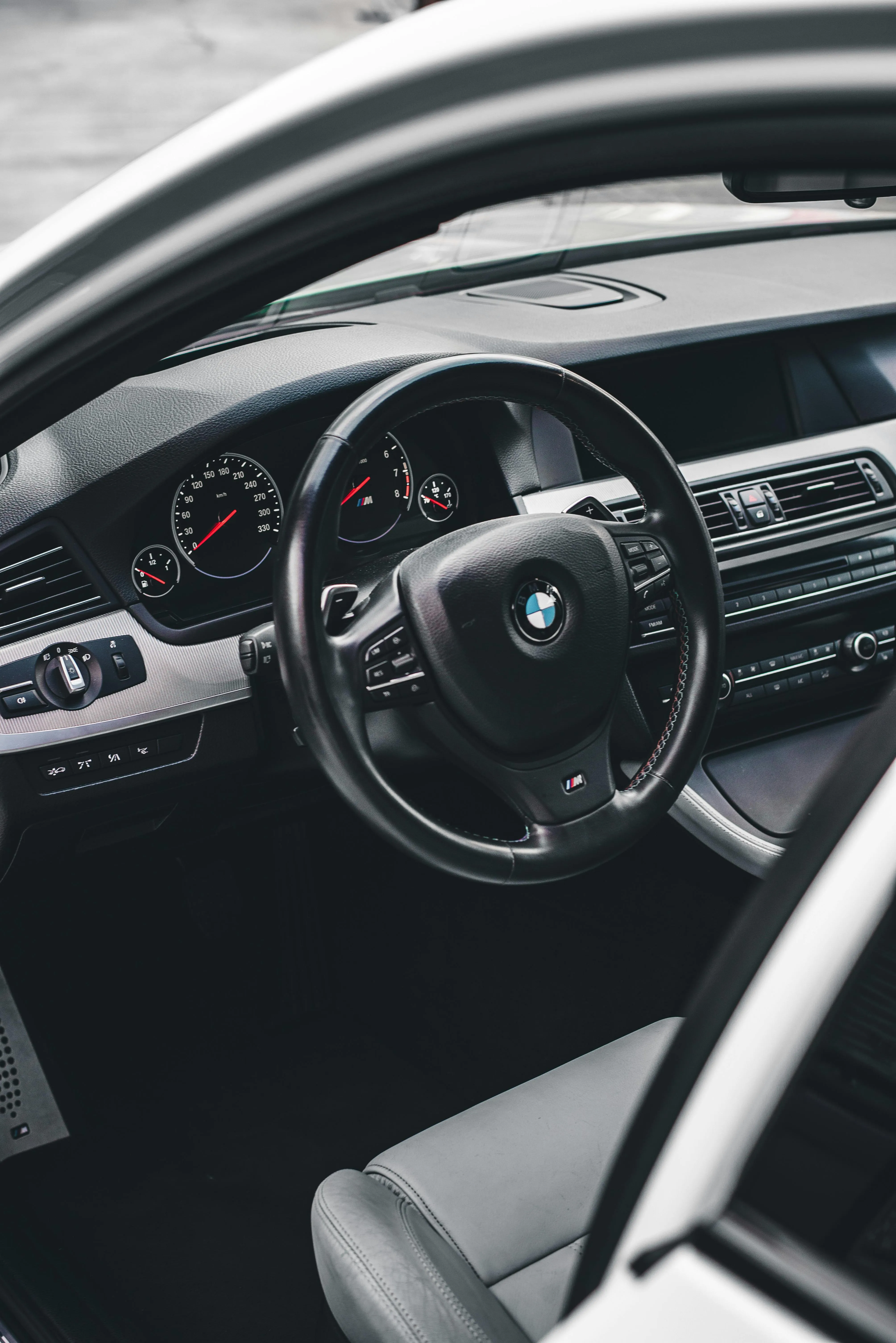 Interior of a Bmw Focusing on the Steering Wheel and Dashboard