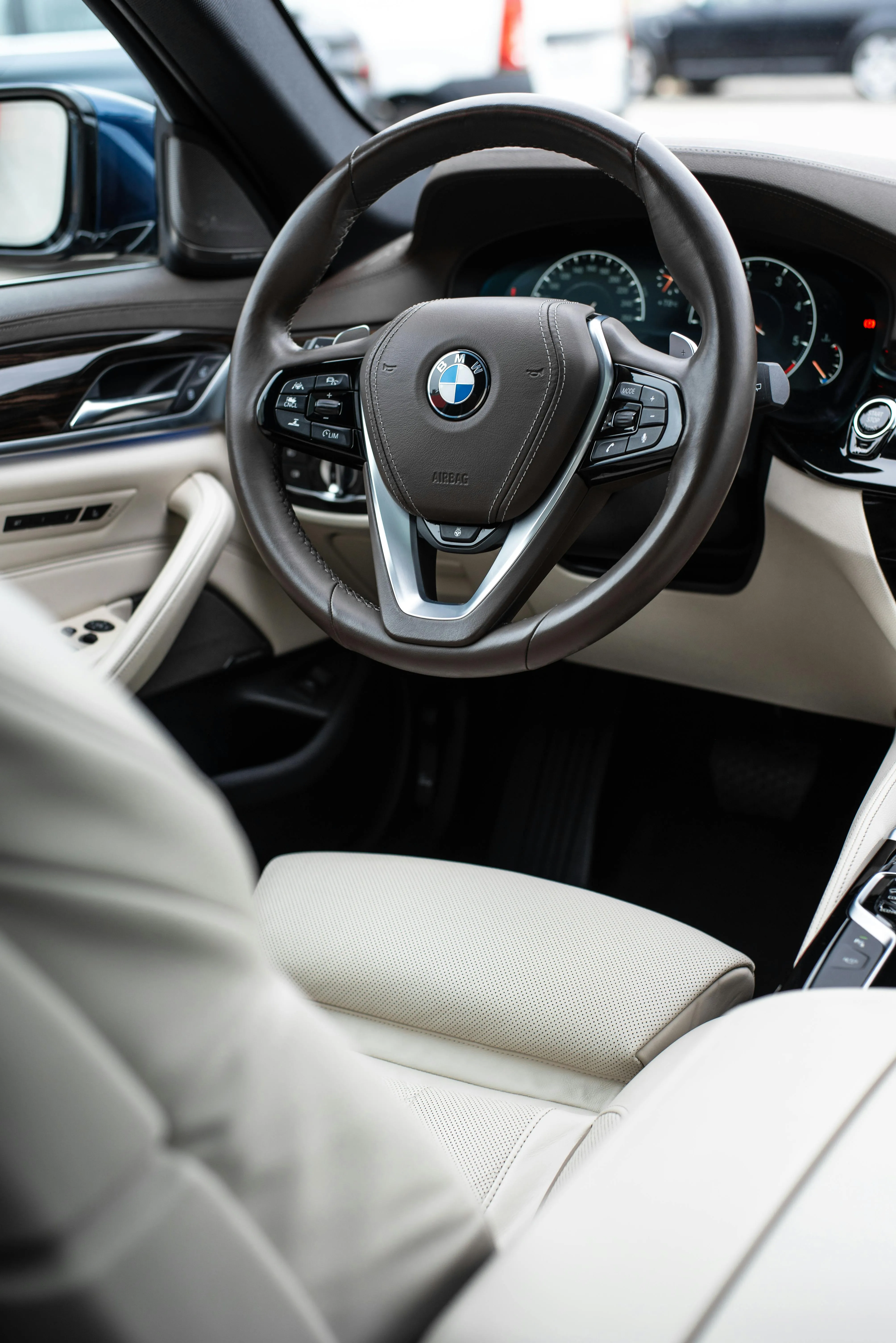 Interior of Bmw Showing Cream Seats and Steering Controls