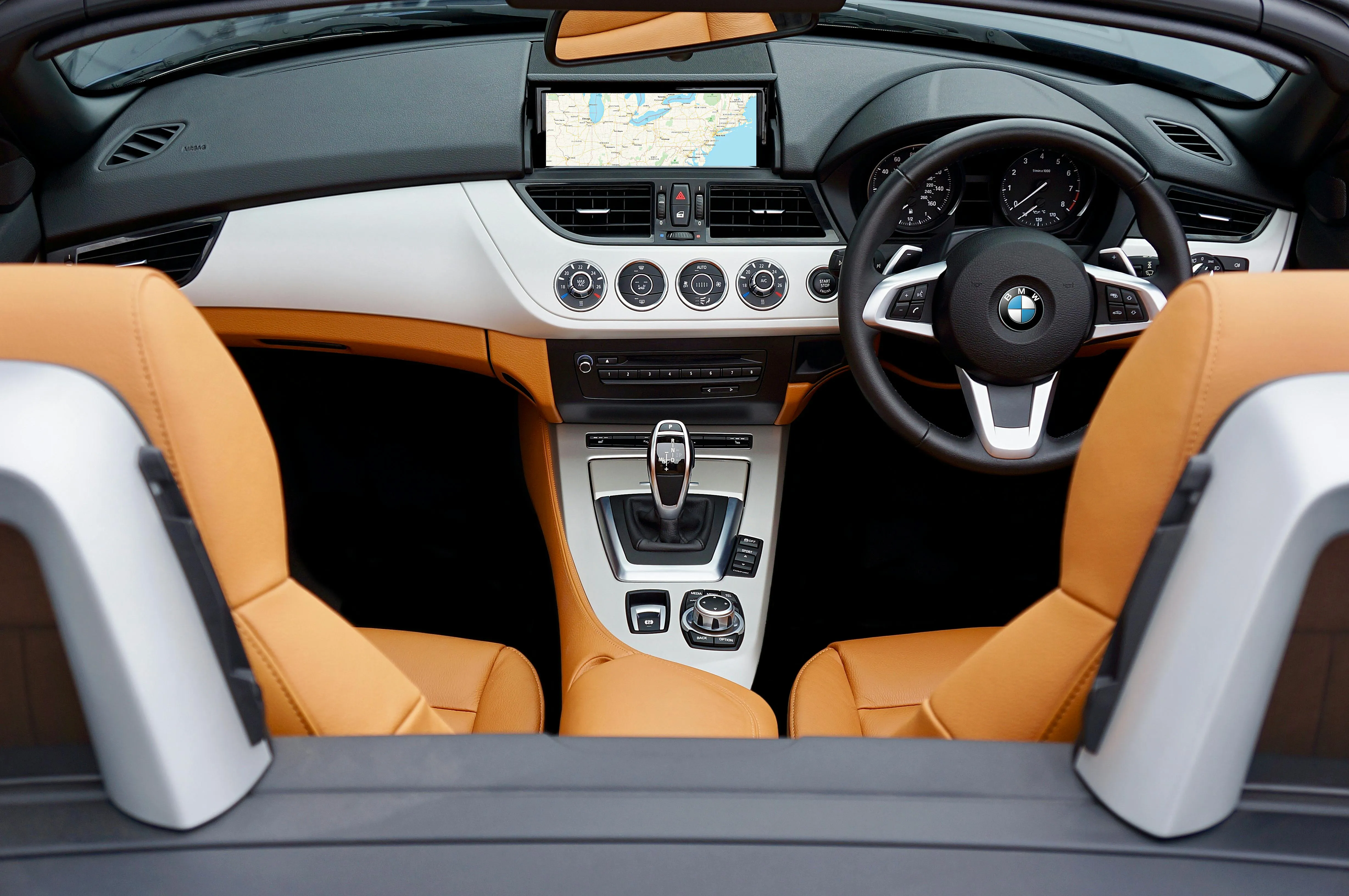 Interior View of a Bmw with Orange Seats and Dashboard