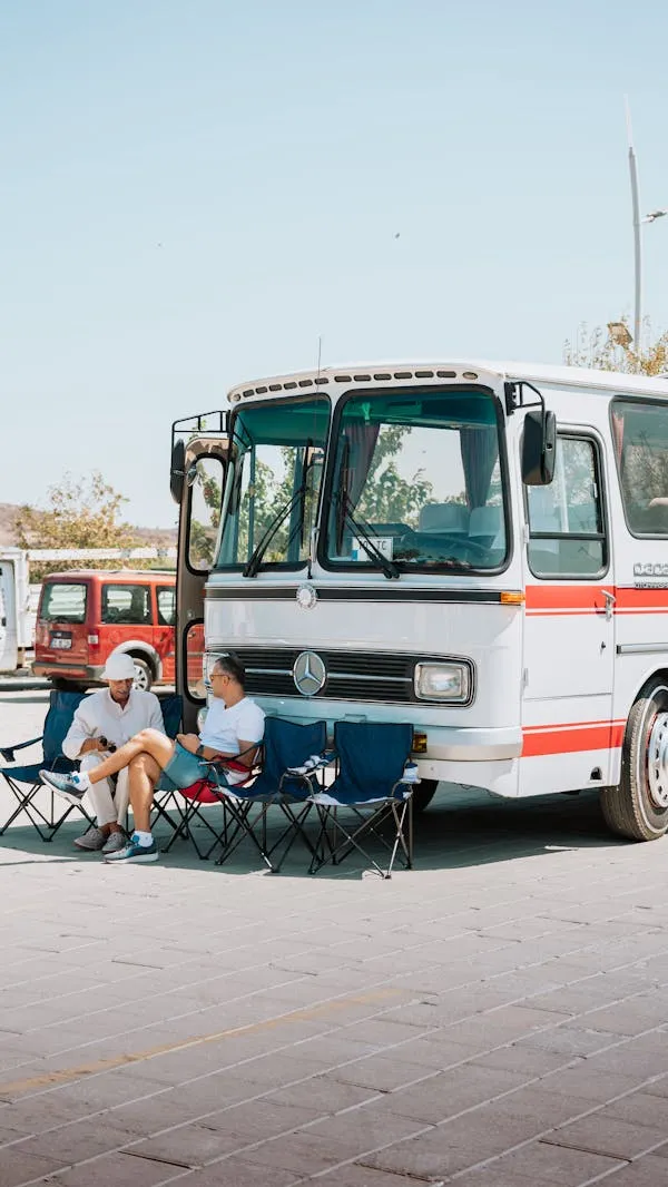 Kids Sitting Near Old Mercedes Benz Bus in City Wallpaper