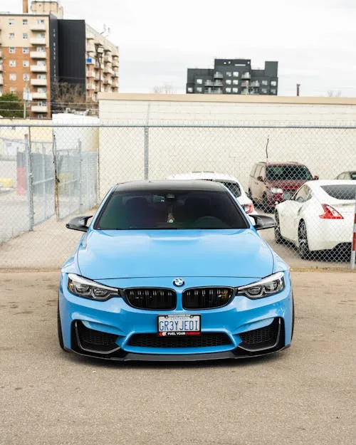 Light Blue Bmw Parked on Road Surrounded By Nature Wallpaper
