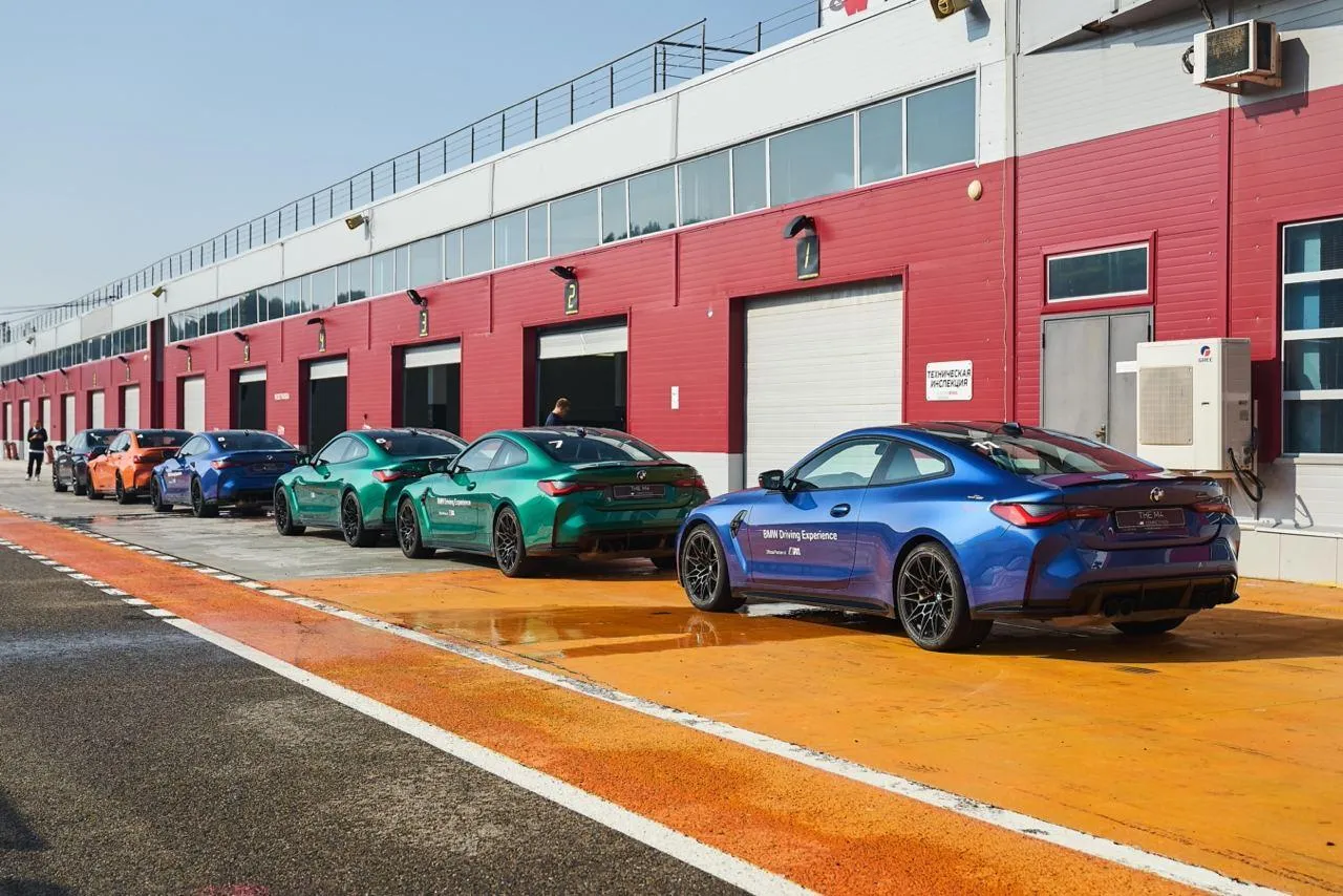 Line of Bmw Cars Parked in the Racing Pit Lane Wallpaper