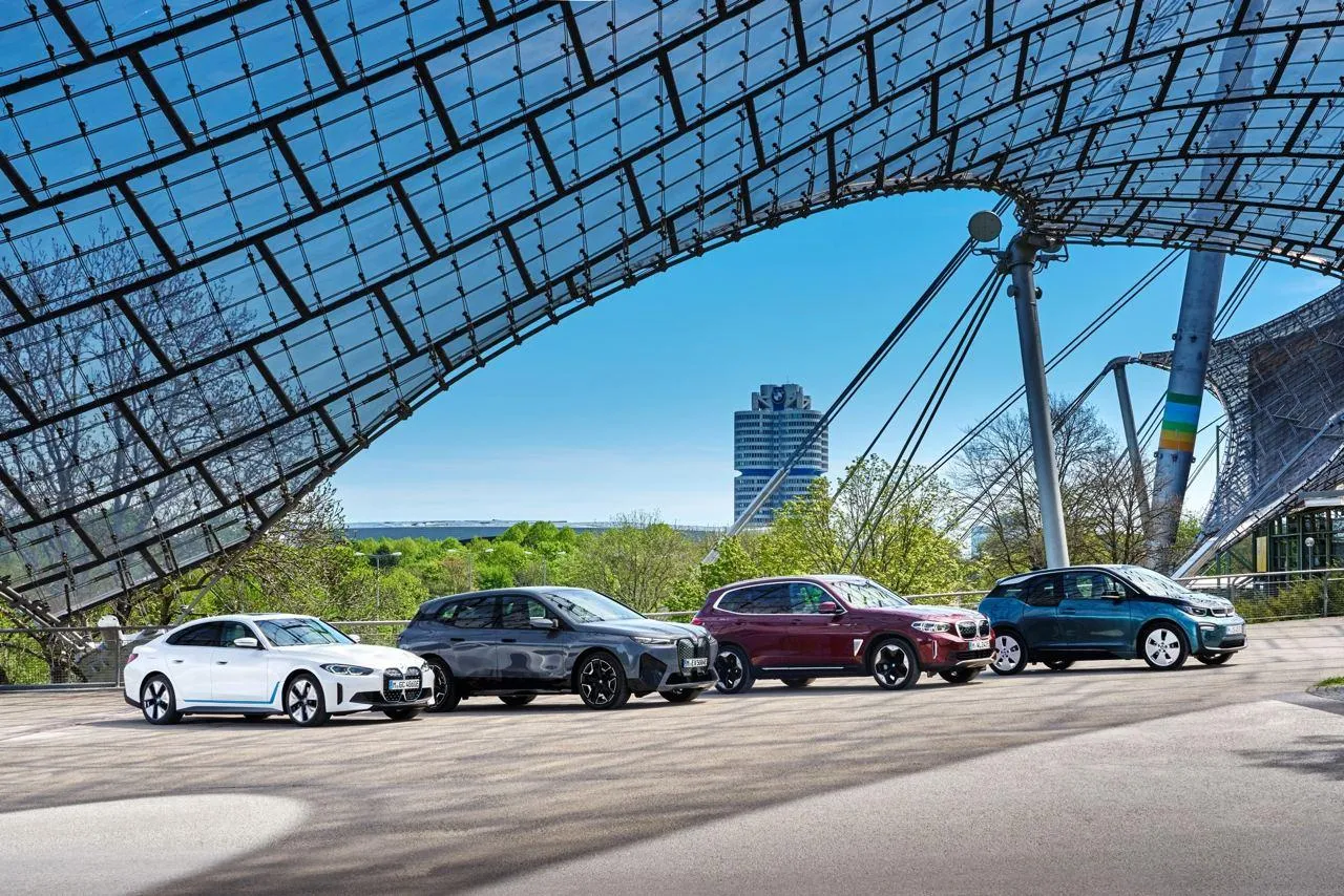 Lineup of Bmw Cars in Front of Futuristic Stadium Wallpaper