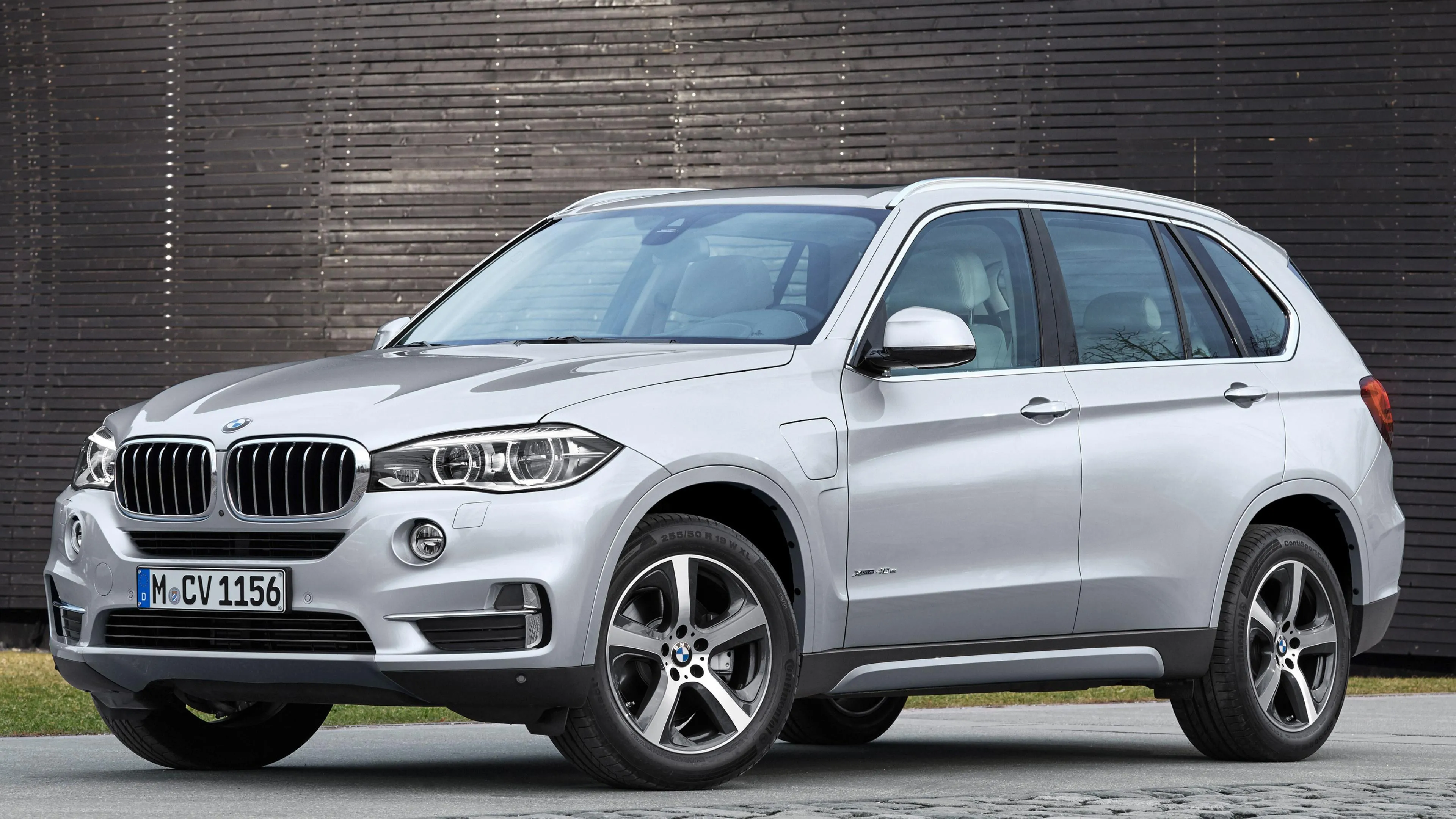 Luxurious White Bmw Suv Parked Outside Modern Building