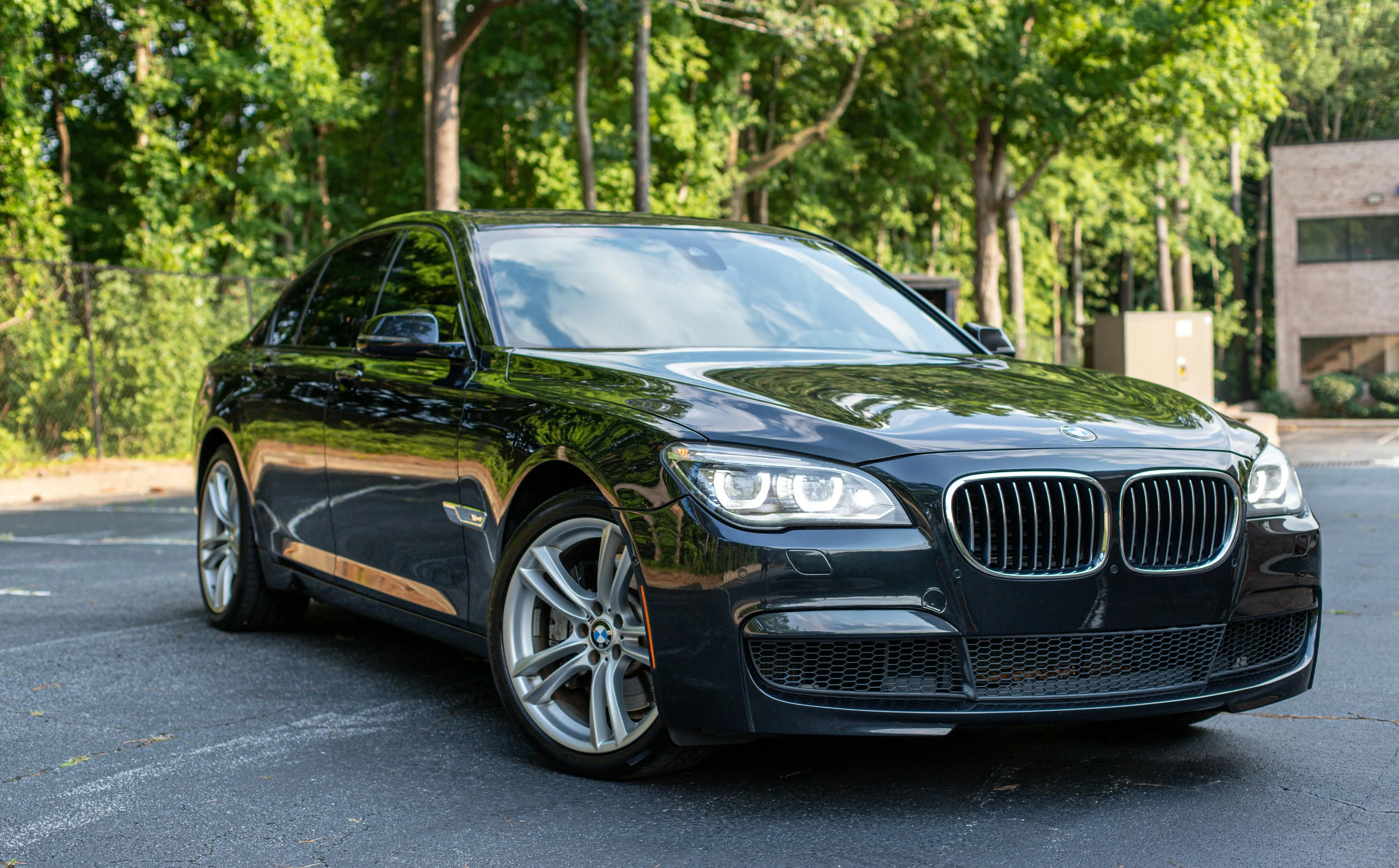 Luxury Black Bmw Parked in Sunny Suburban Street View