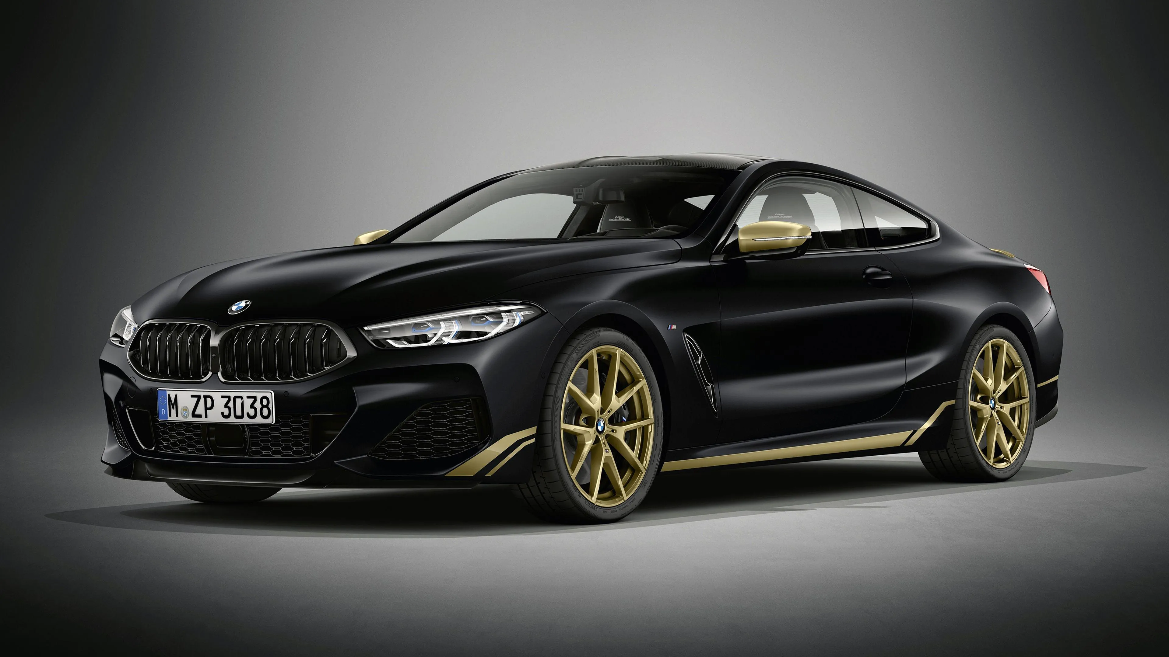 Luxury Black Bmw with Gold Trim Under Studio Lighting
