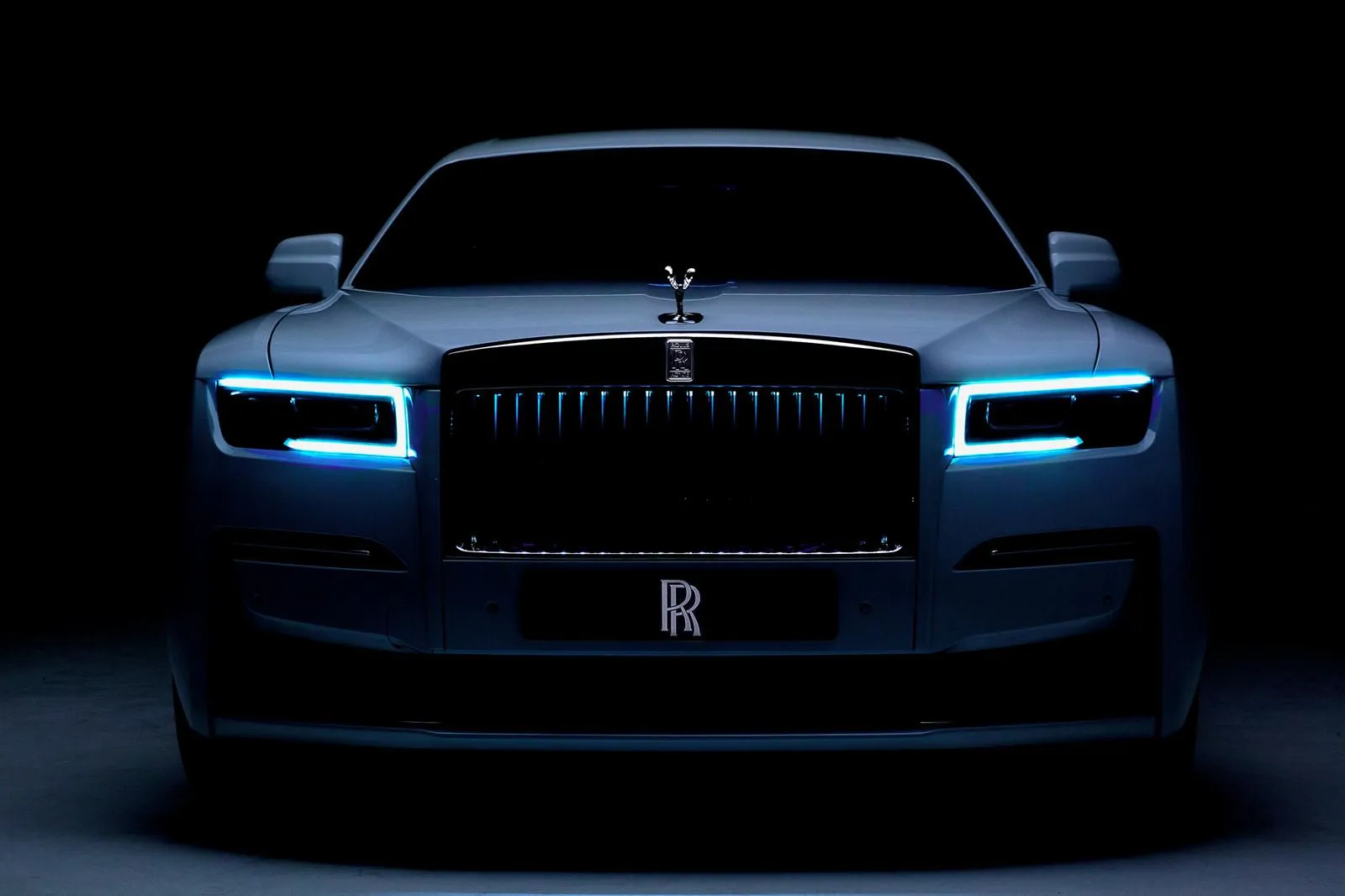 Luxury car showcased with glowing lights in dark setting