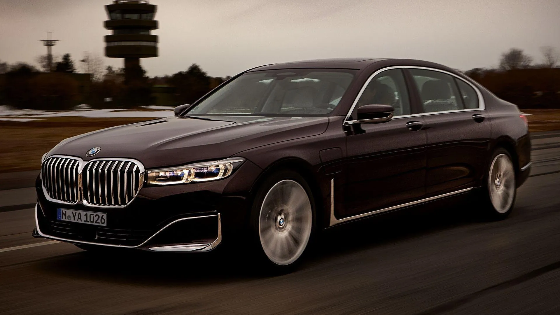 Luxury Dark Bmw Sedan Parked on Road Under Cloudy Sky
