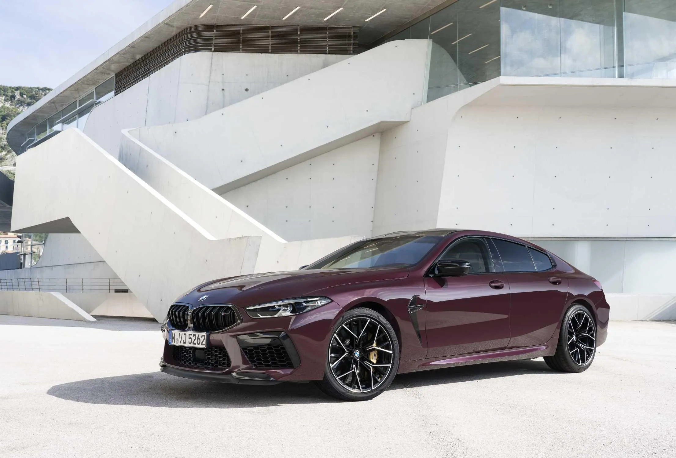 Luxury Maroon Bmw Coupe Parked Outside Futuristic Building