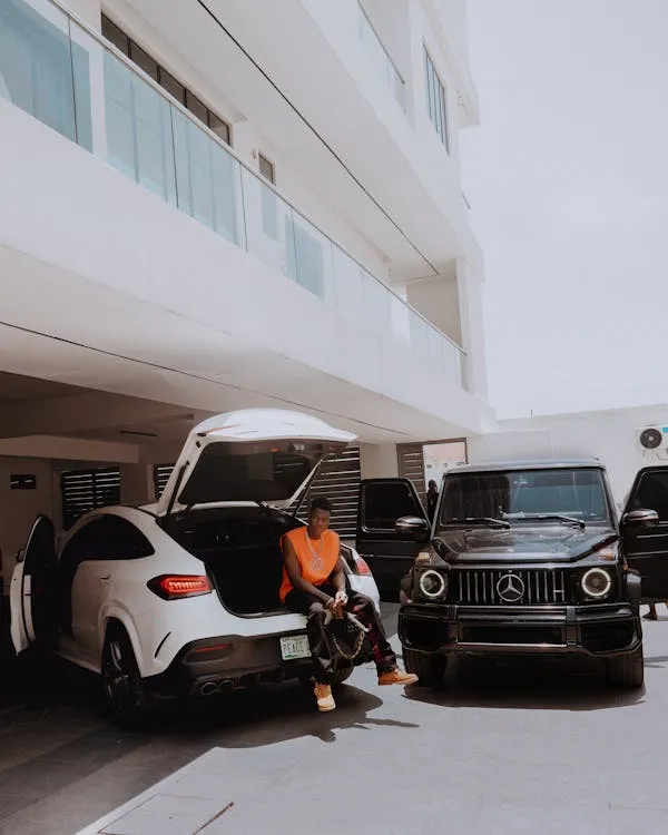 Luxury Mercedes Benz Cars Parked Outside Building Wallpaper