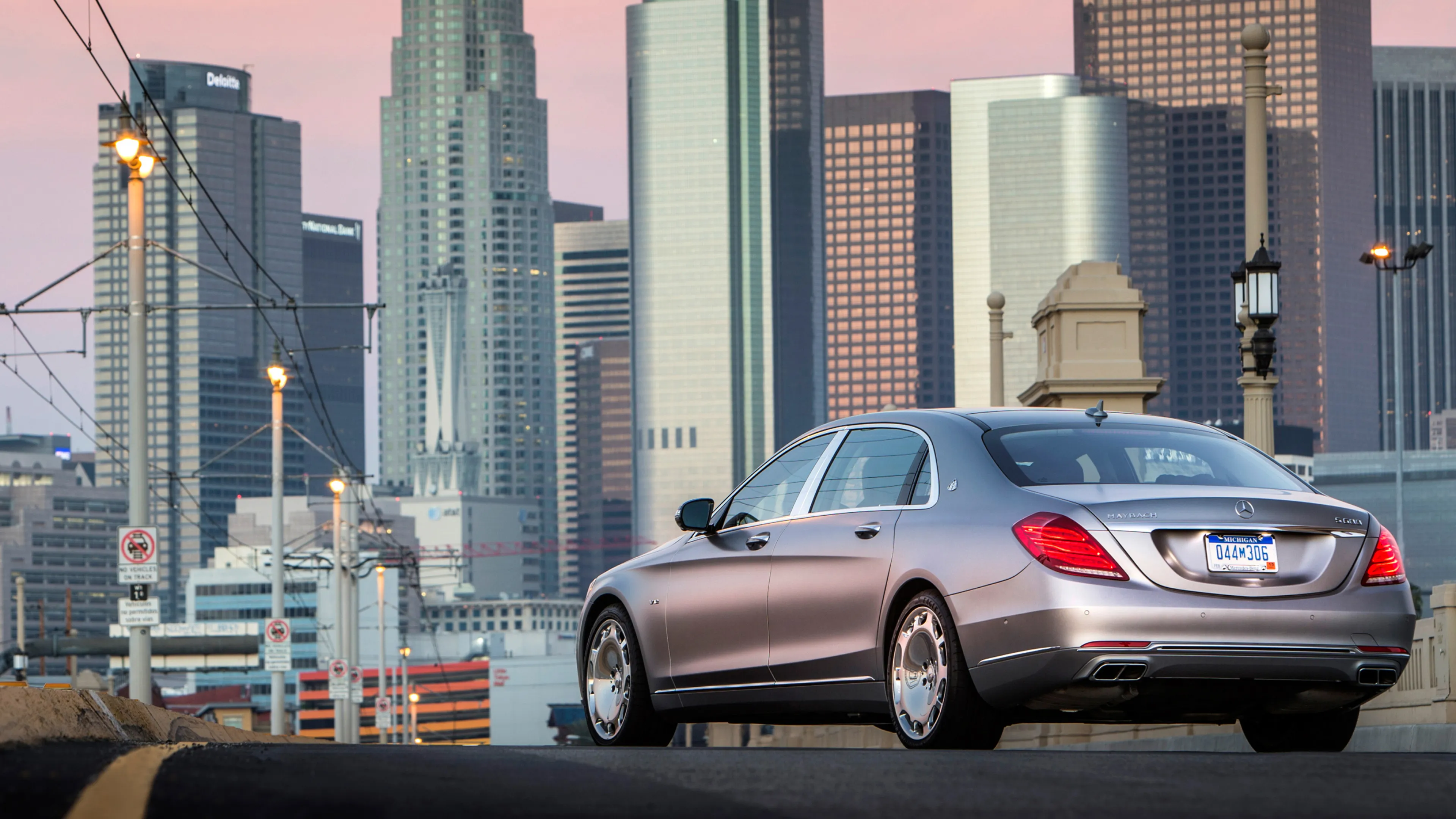 Luxury Mercedes Benz Sedan Parked Against City Skyline
