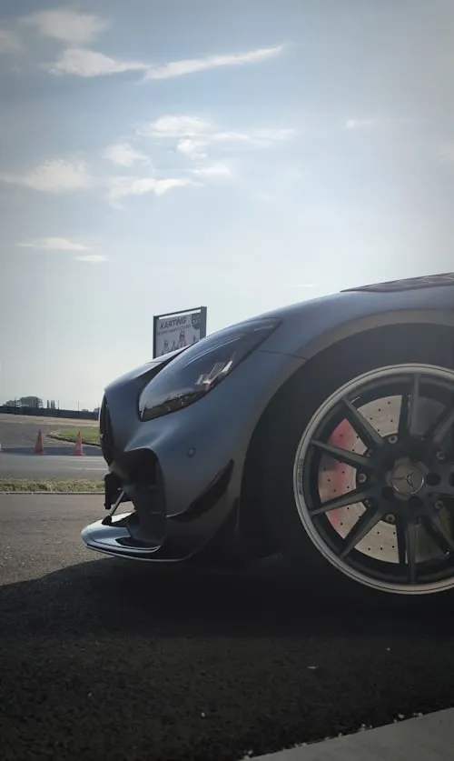 Luxury Mercedes sports car parked under clear sky Wallpaper