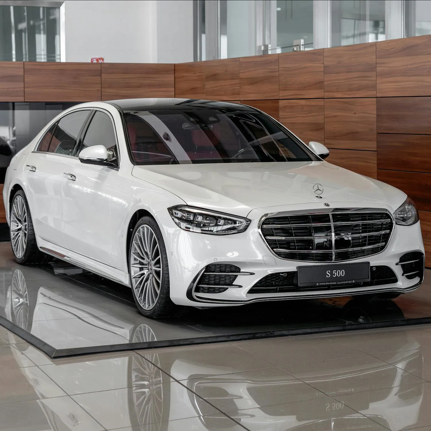 Luxury White Mercedes Benz in Modern Showroom Wallpaper