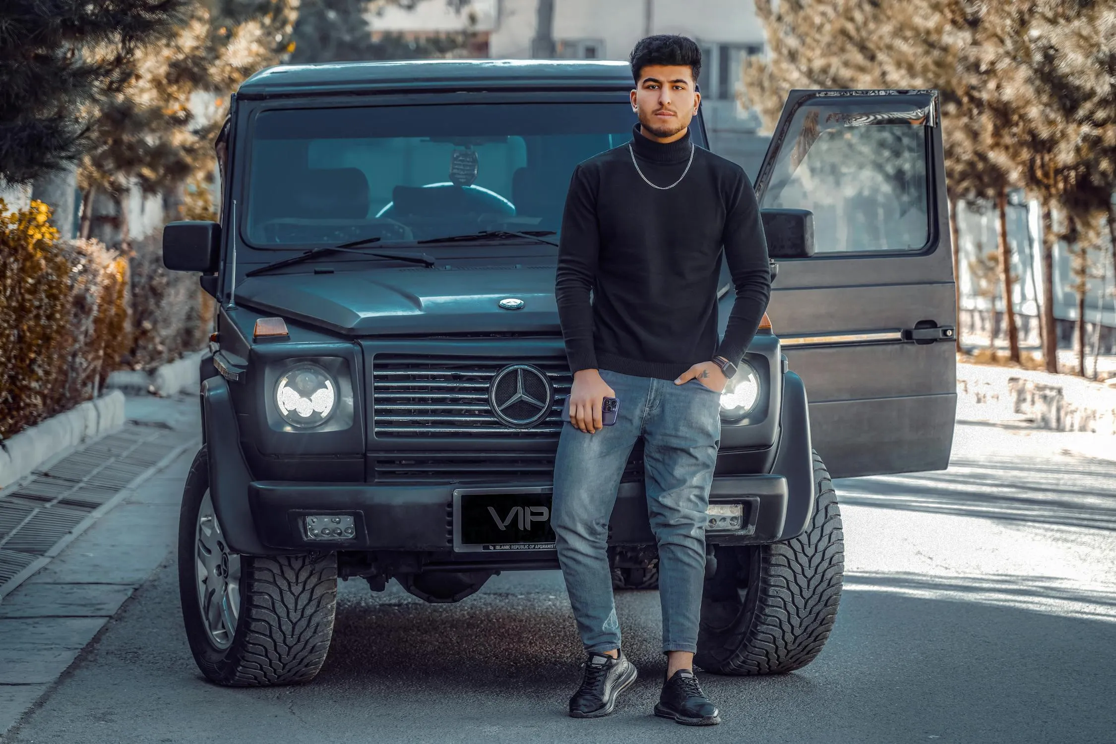 Man Standing Next To Black Mercedes G Wagon SUV Wallpaper