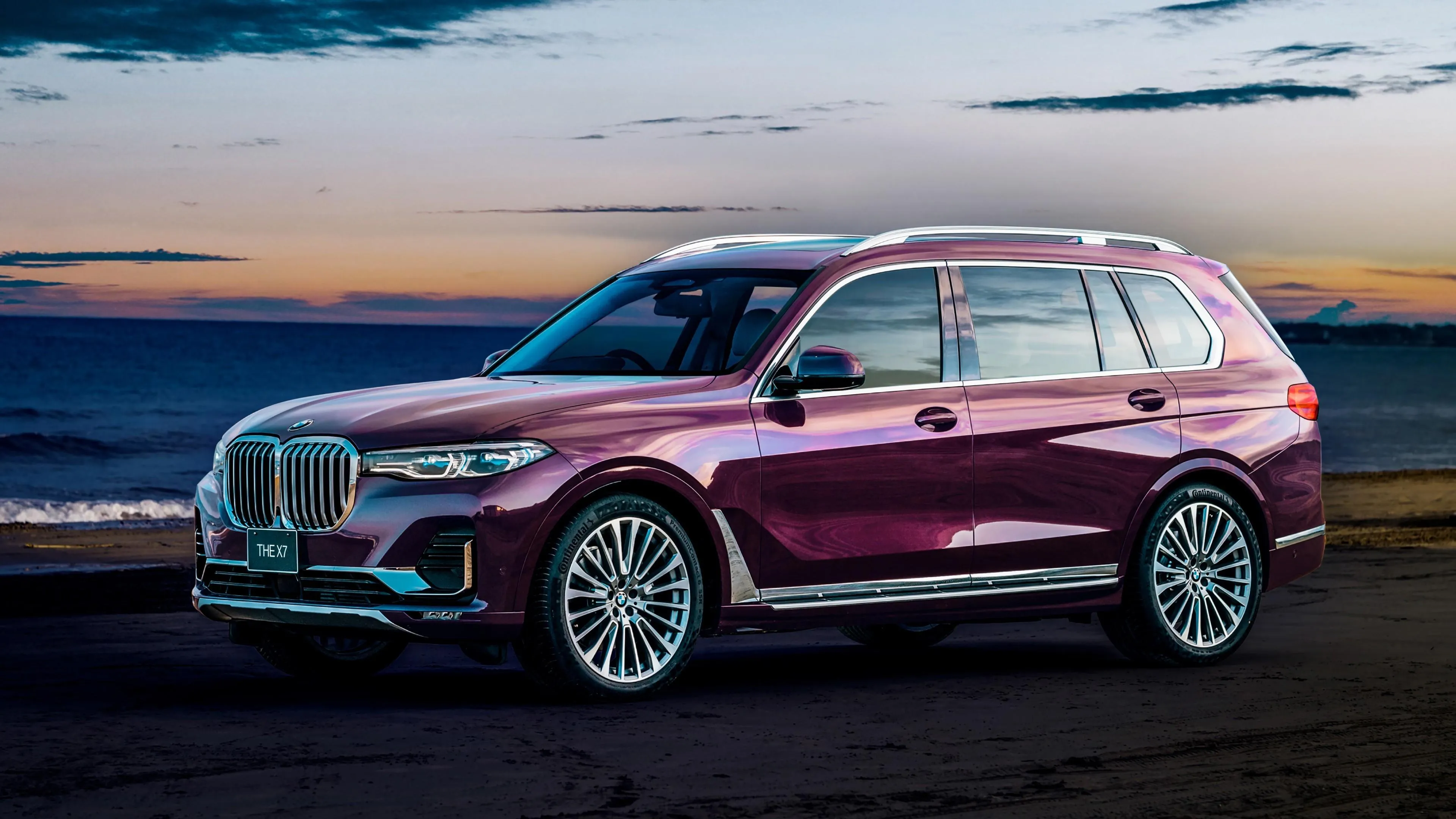 Maroon Bmw Suv Parked Near Ocean Under Dramatic Sky