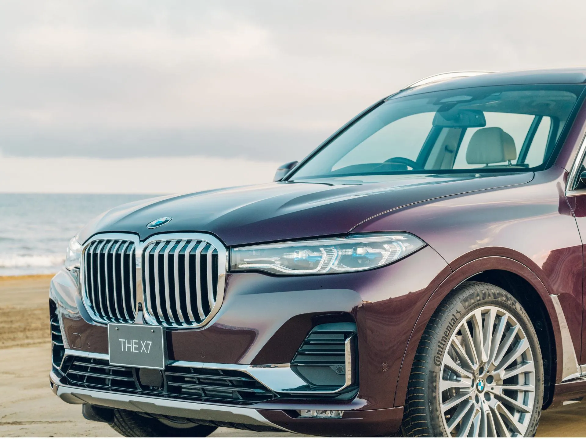 Maroon Bmw Suv Parked on a Beachfront Street with Ocean View