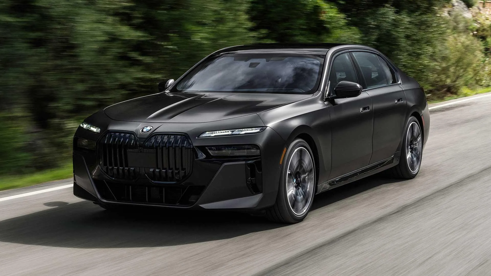 Matte Black Bmw Cruising Through Suburban Road Wallpaper