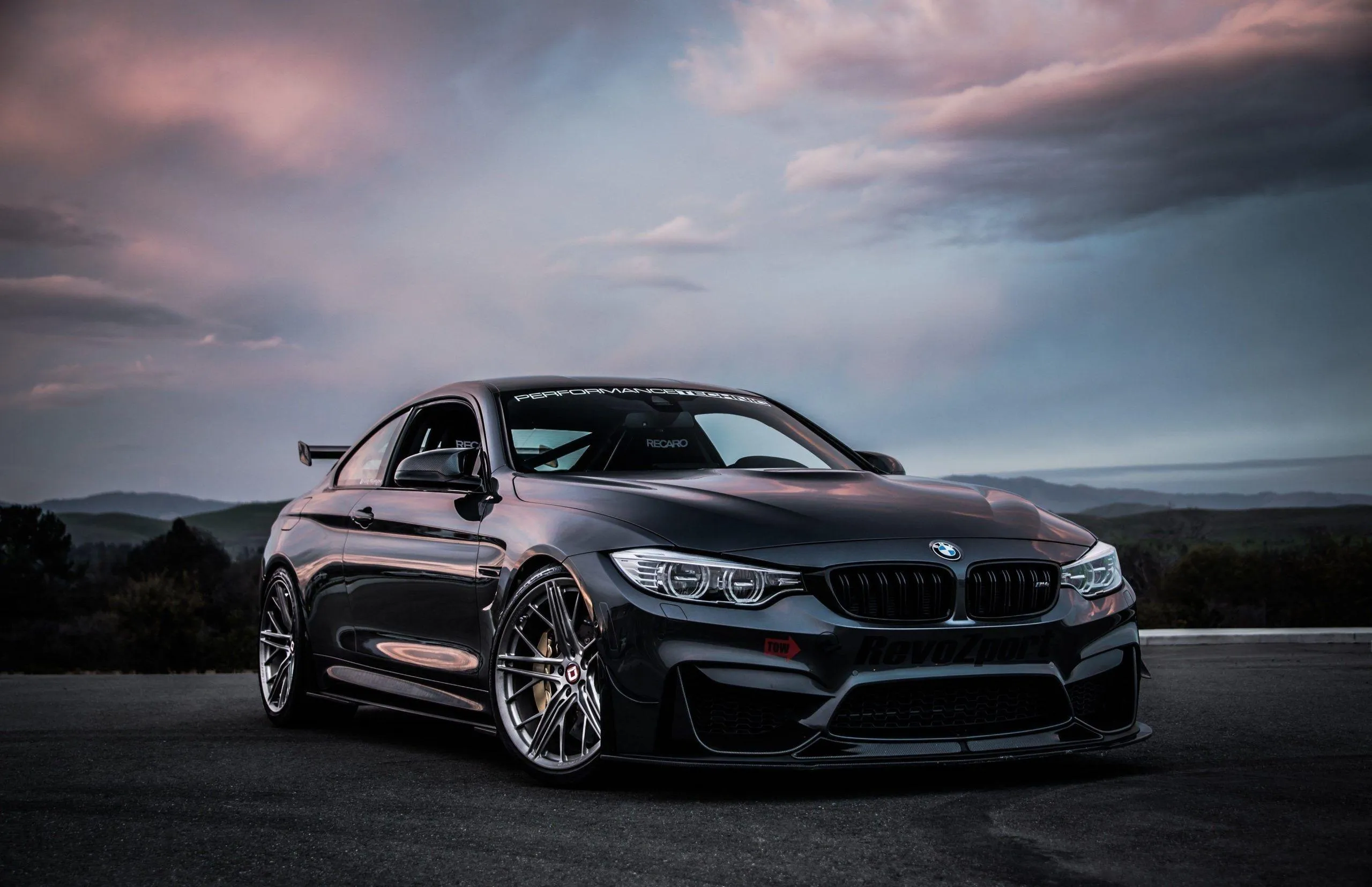 Matte Black Bmw Parked Under a Cloudy Sky at Dusk Image