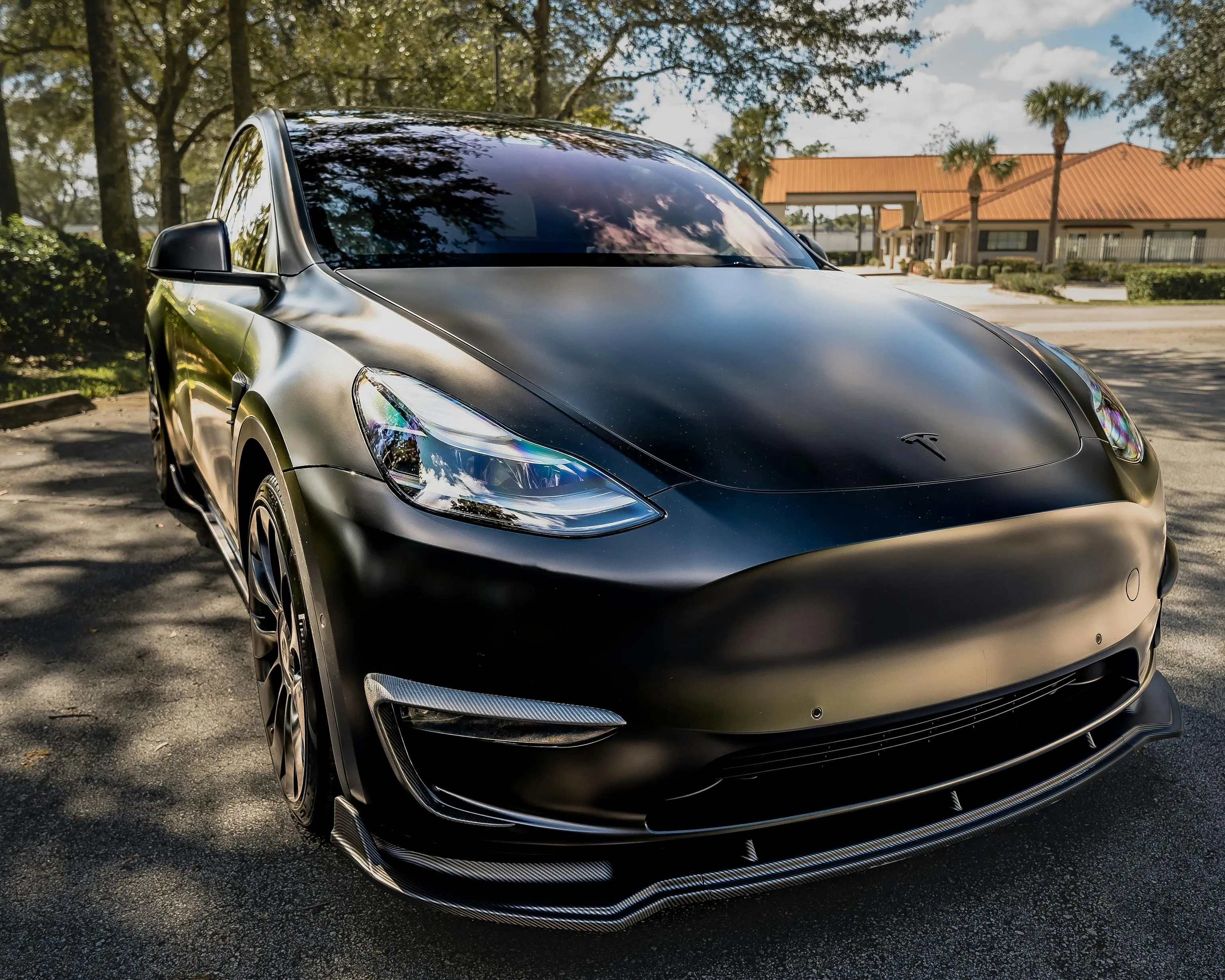 Matte Black Tesla Model Y in Daytime Parking Lot HD portrait