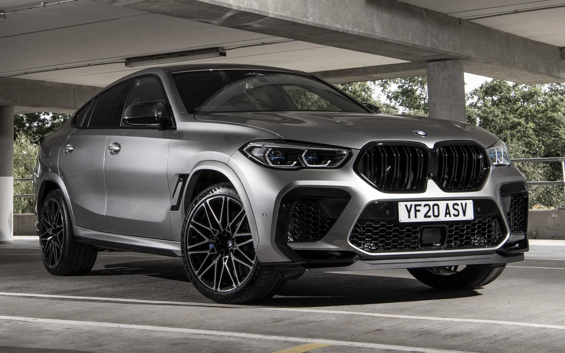 Matte Grey Bmw Suv Parked Under Urban Structure Image