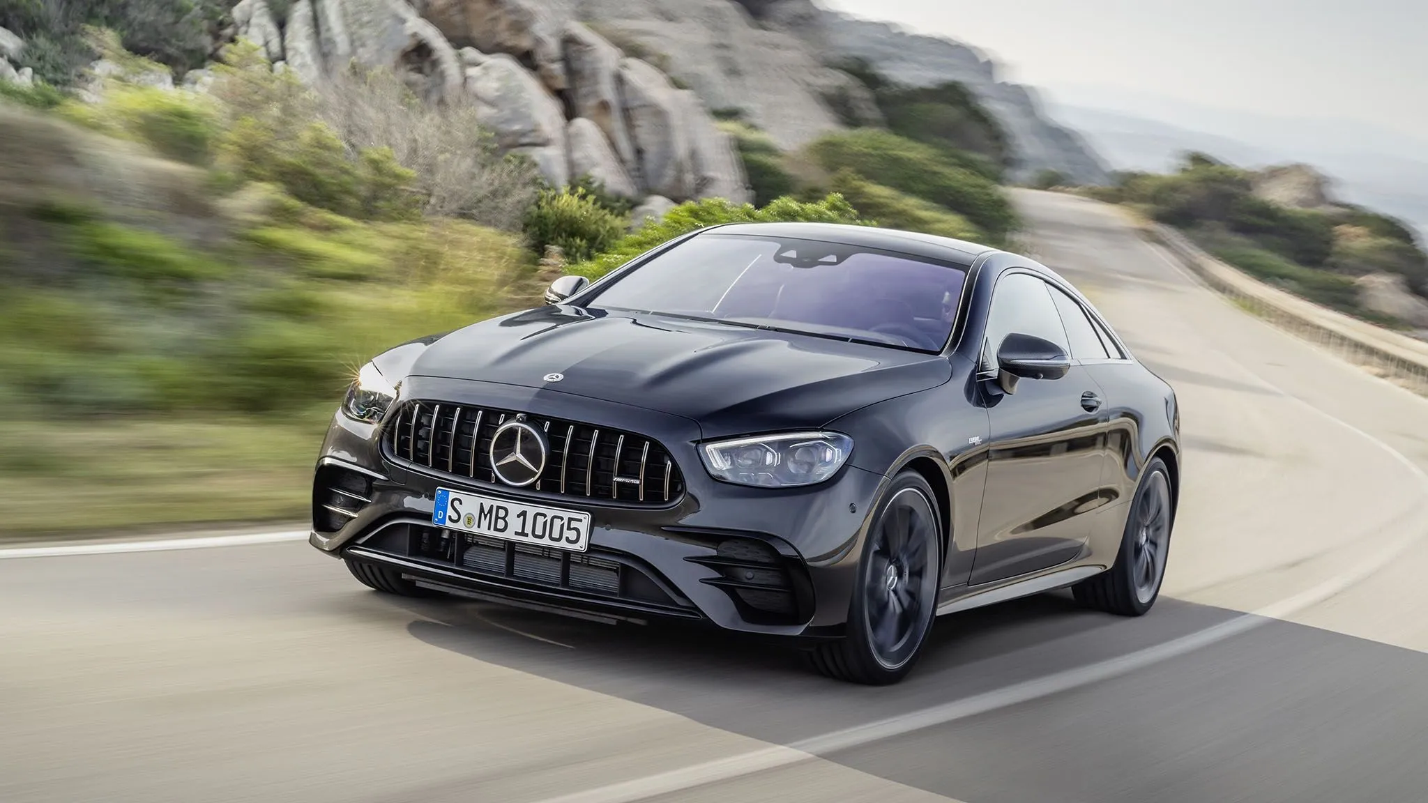 Mercedes AMG Driving Fast on Curved Mountain Road image