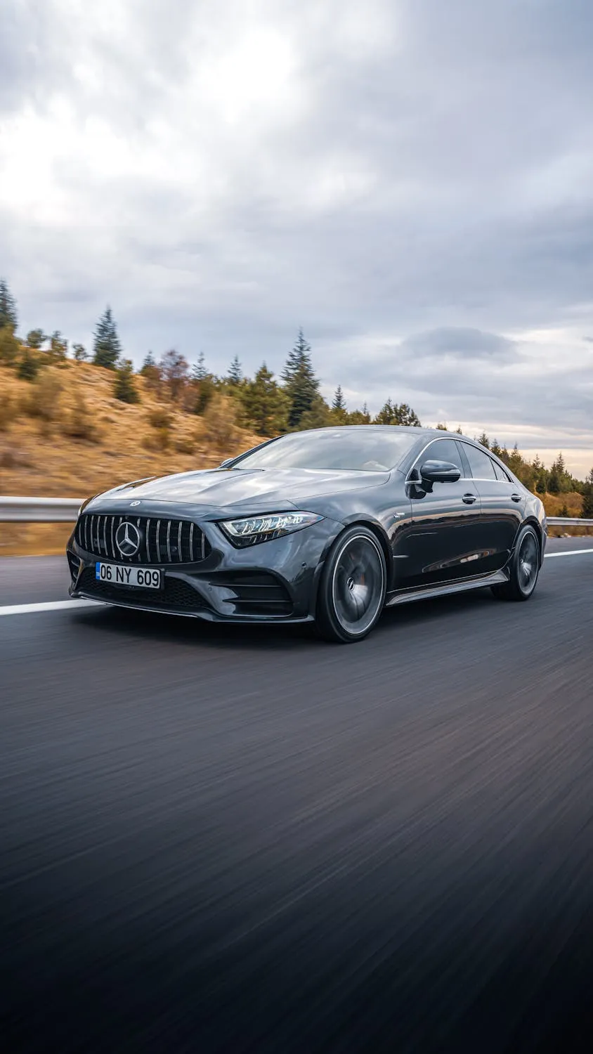 Mercedes AMG Driving Fast on Scenic Open Highway image