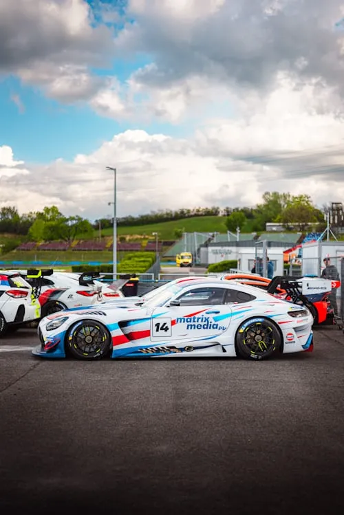 Mercedes AMG GT Race Cars on Track with Bright Sky image