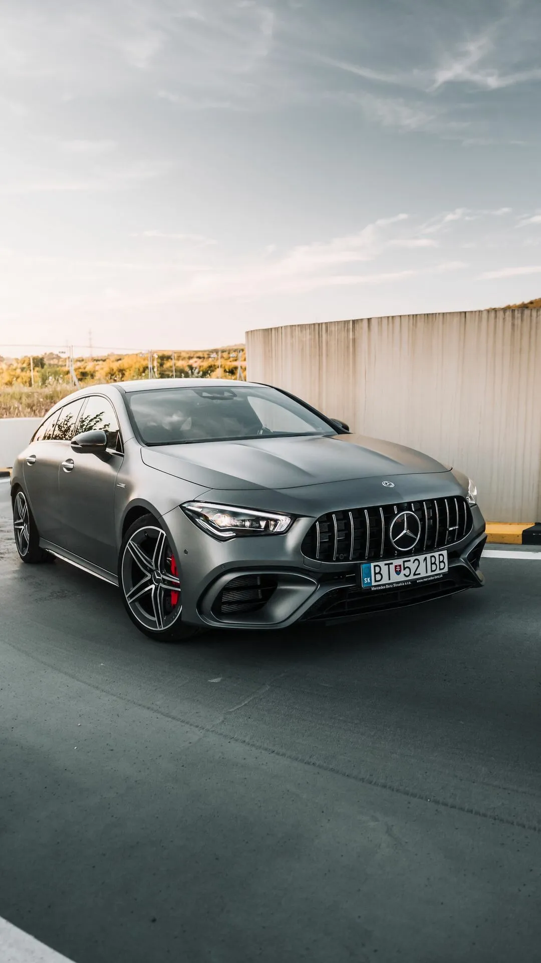 Mercedes Benz AMG Sedan Parked on Rooftop with Sunset
