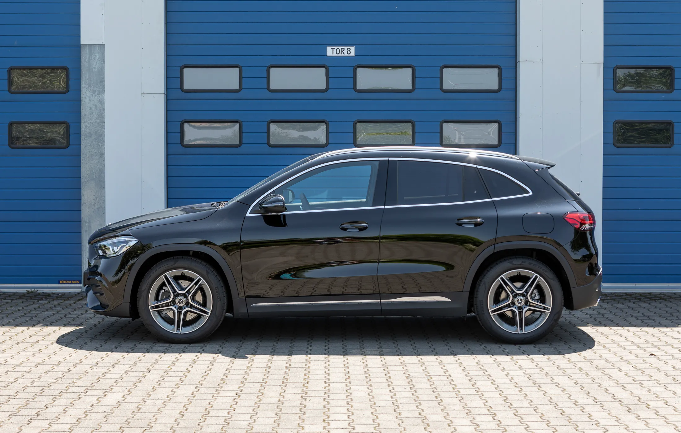 Mercedes Benz Black SUV Parked in Front of Industrial Gate