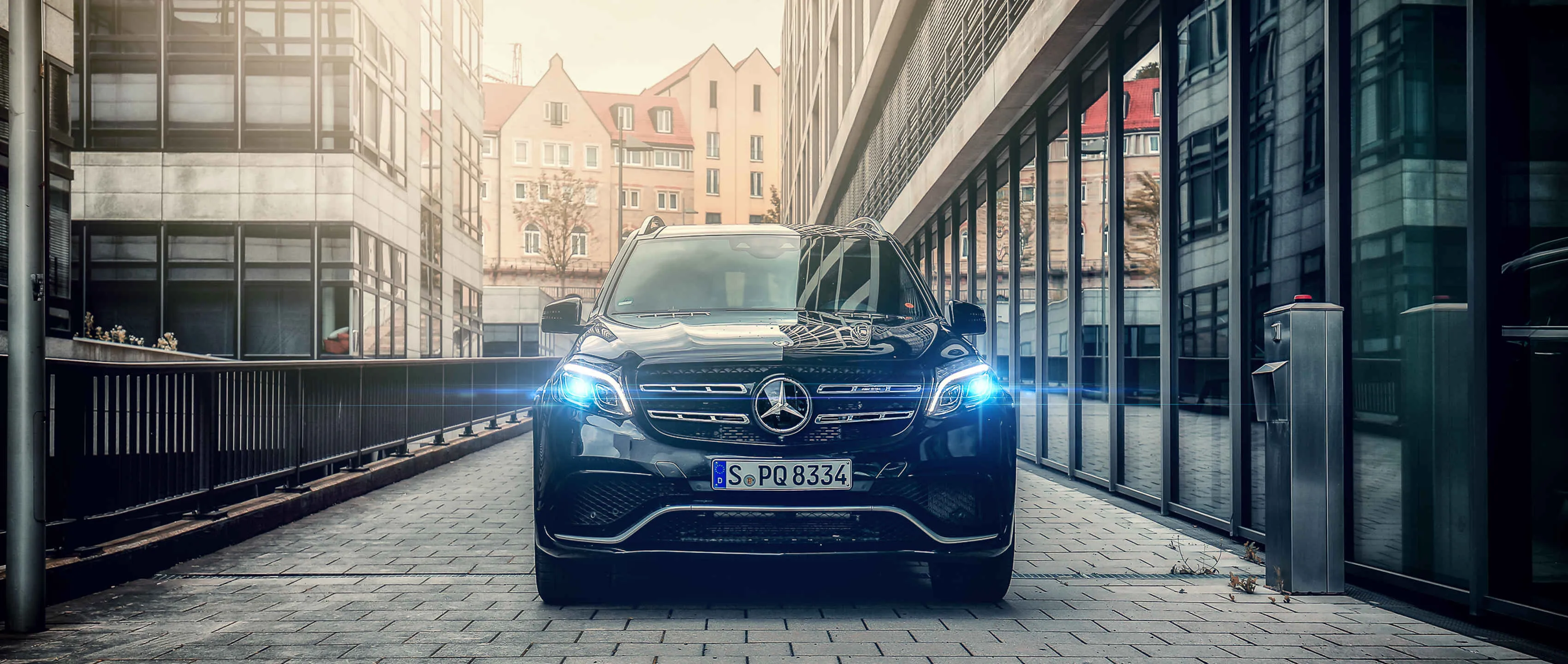 Mercedes Benz Car with Headlights On in City Street HD