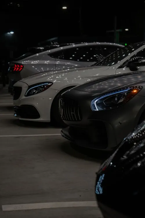 Mercedes Benz Cars Lined Up at Night in Urban Showroom