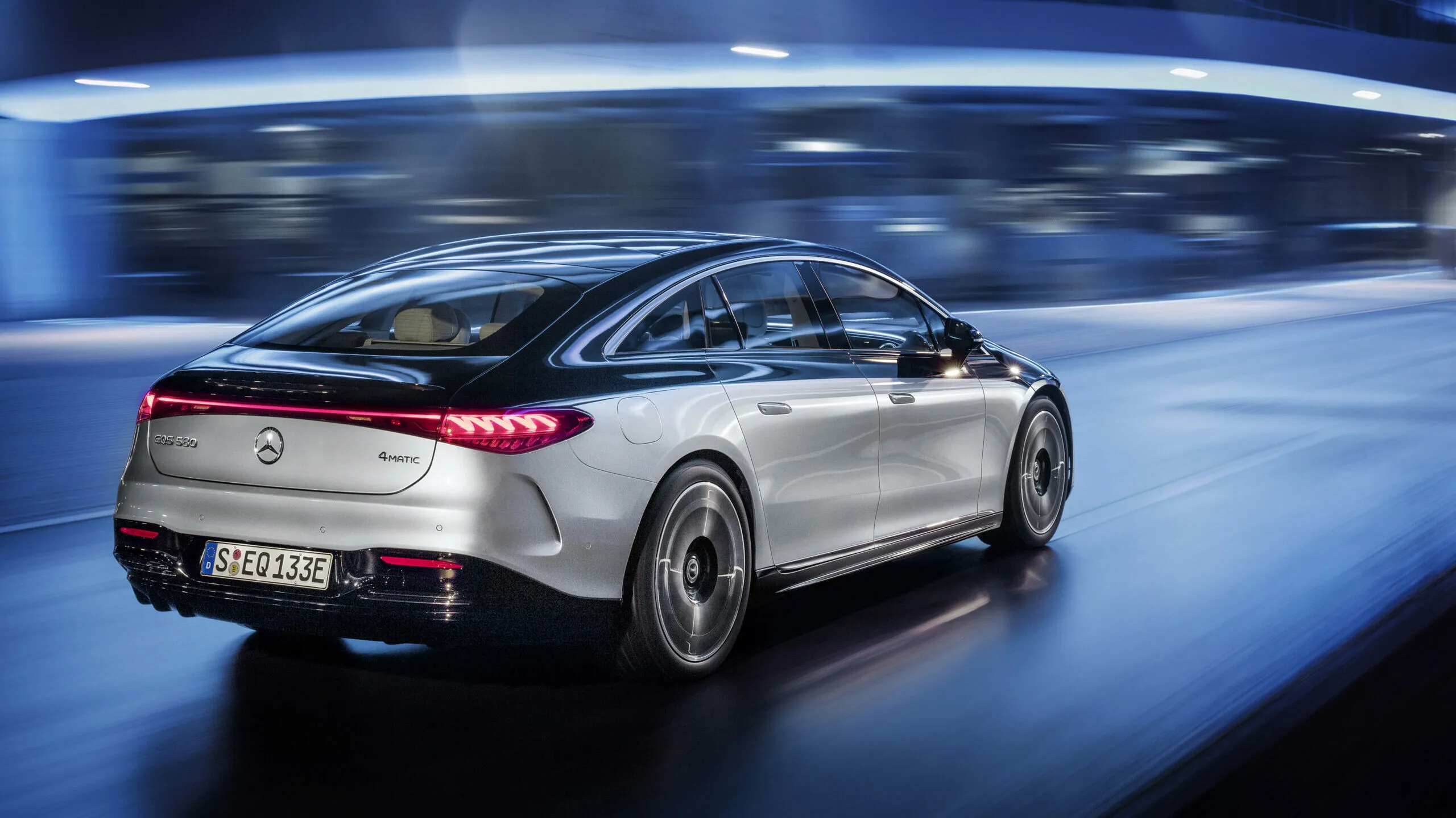 Mercedes Benz Electric Sedan in Motion with City Lights