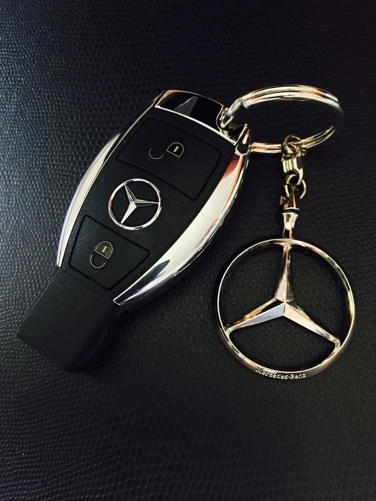 Mercedes Benz Key Fob and Emblem on Black Surface Wallpaper