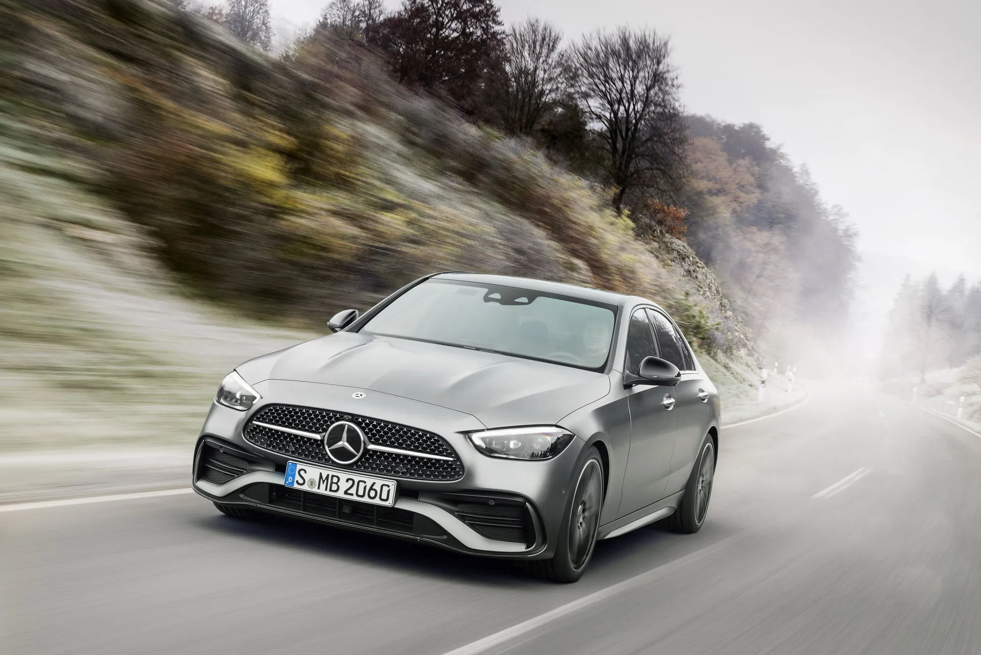 Mercedes Benz Sedan Cruising on a Snowy Mountain Road