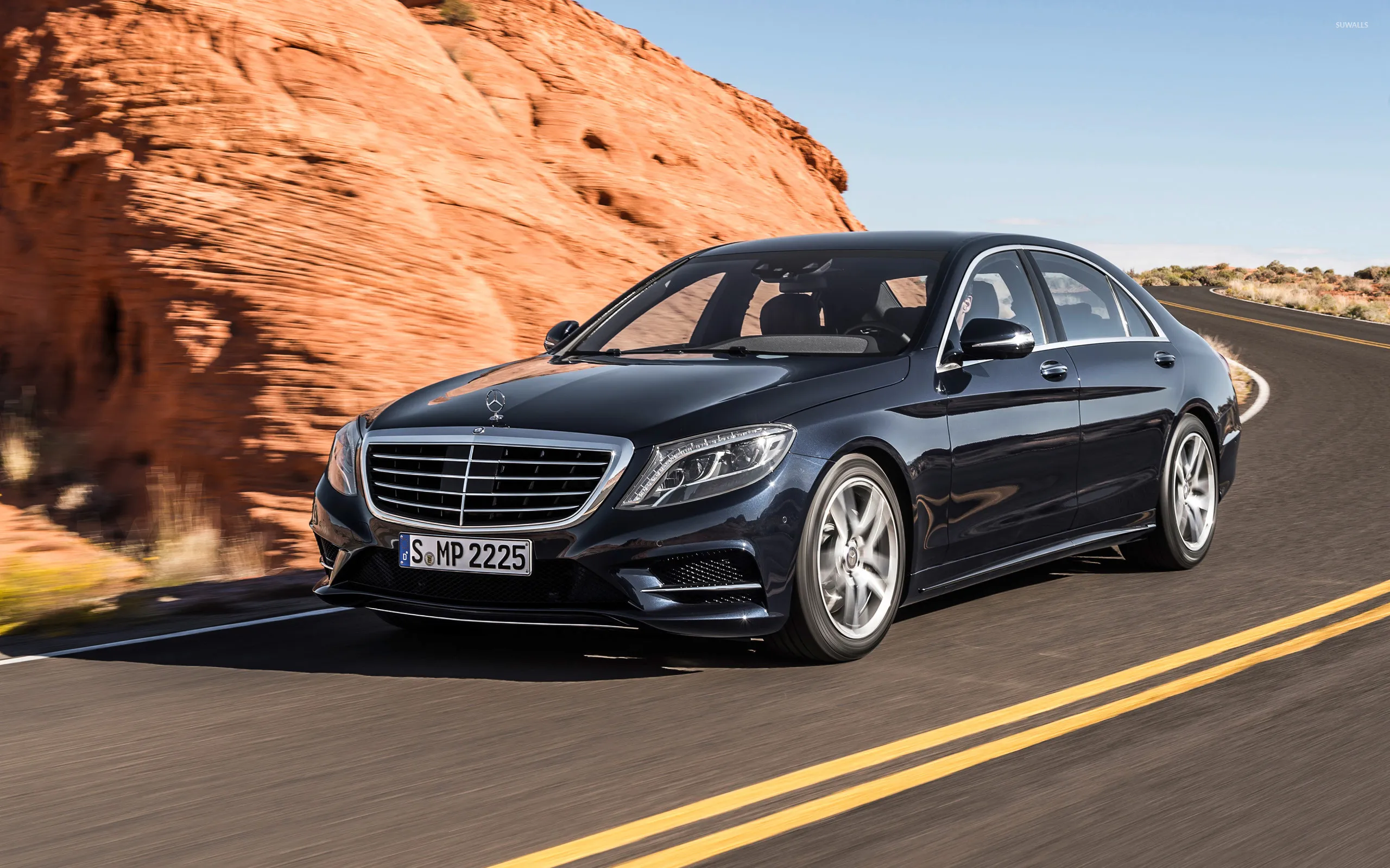 Mercedes Benz Sedan Driving on Desert Road by Red Rocks