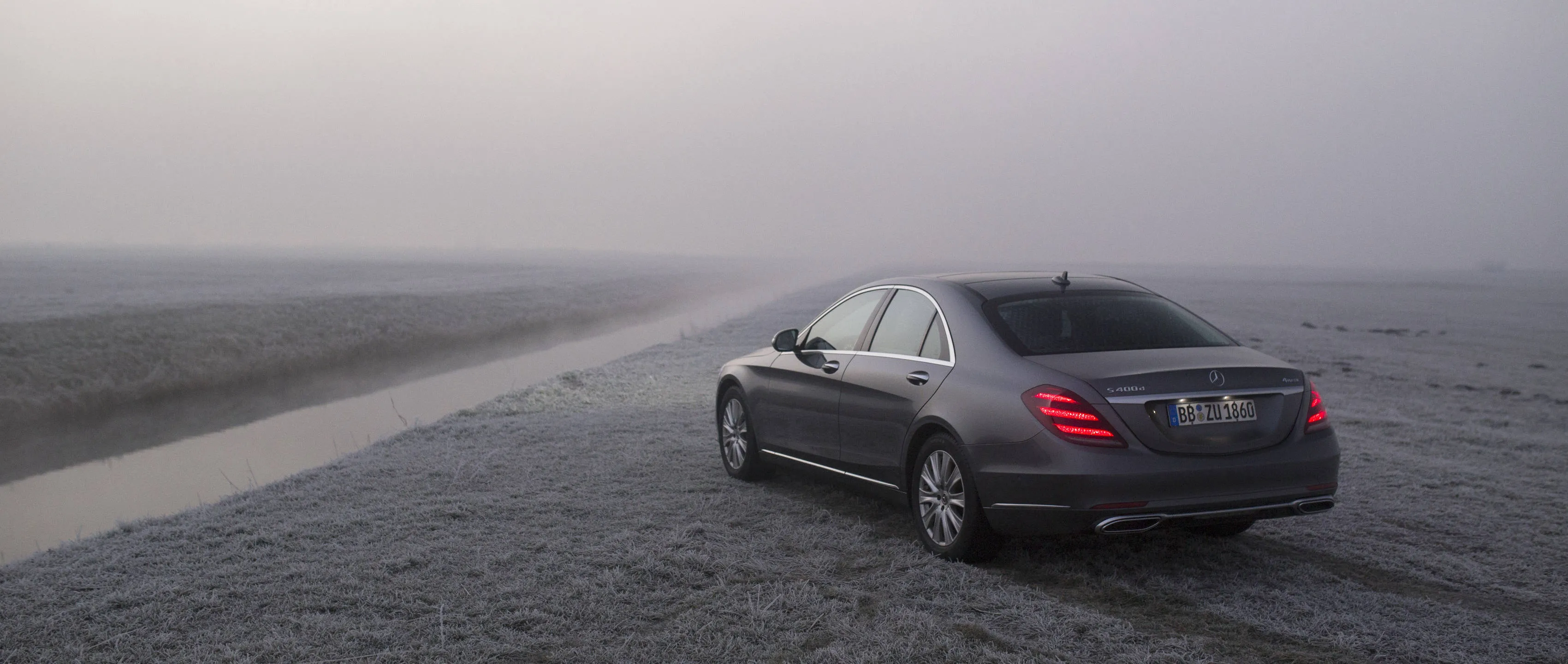 Mercedes Benz Sedan Driving on Foggy Coastal Road image
