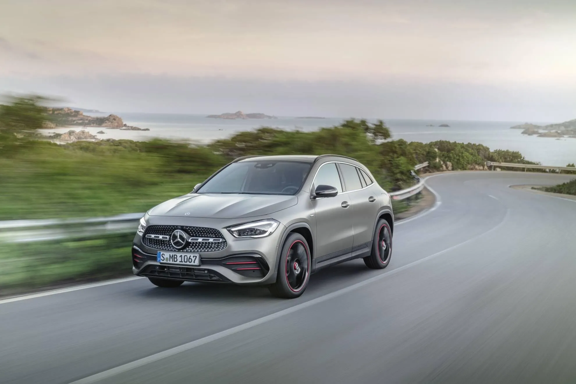 Mercedes Benz Sedan Driving on Scenic Coastal Road Wallpaper