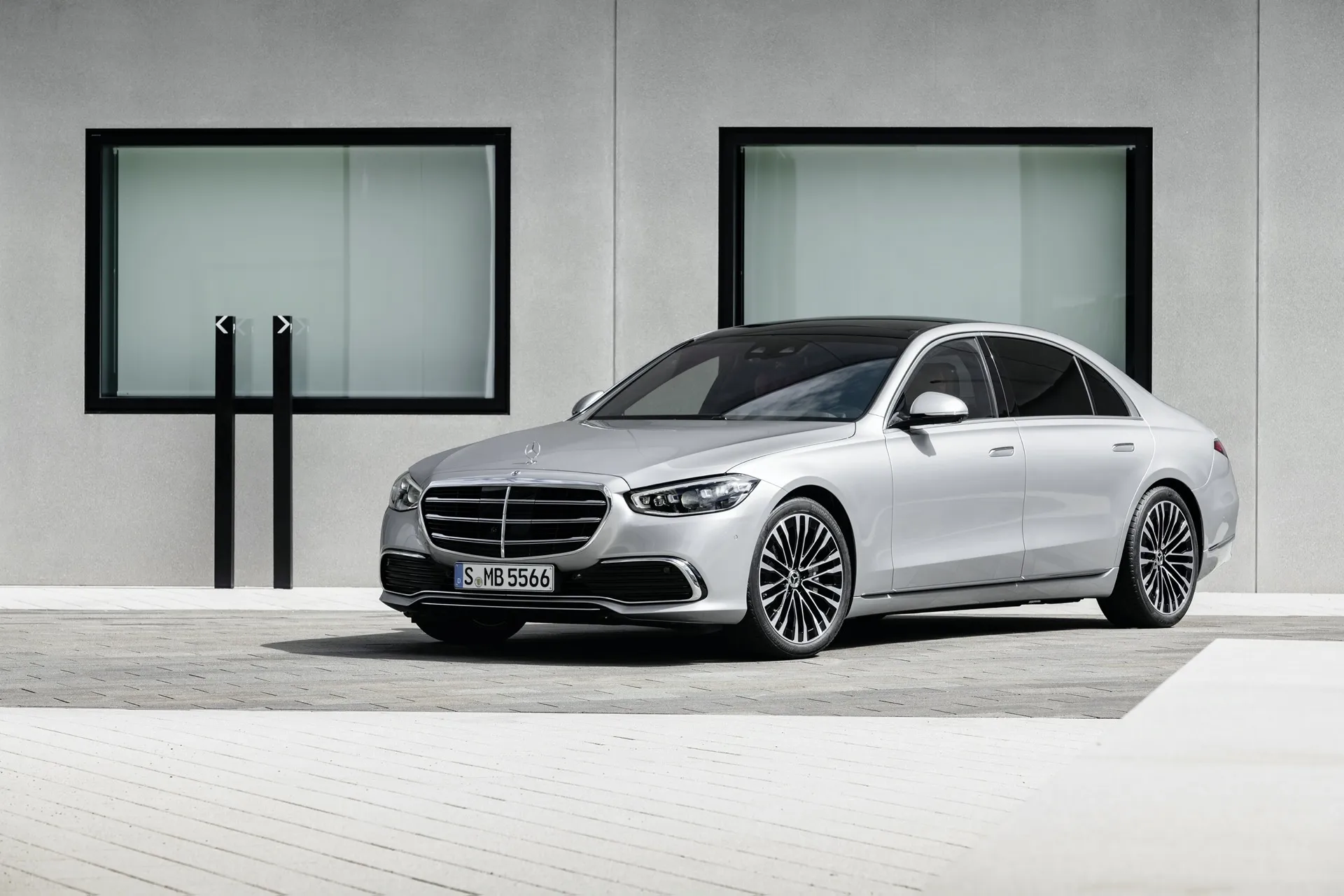 Mercedes Benz Sedan Parked by Modern Building Wall image