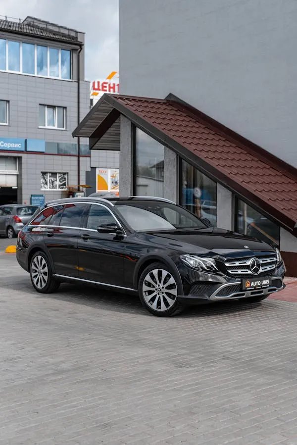 Mercedes Benz Sedan Parked Near Urban Shopping Area image