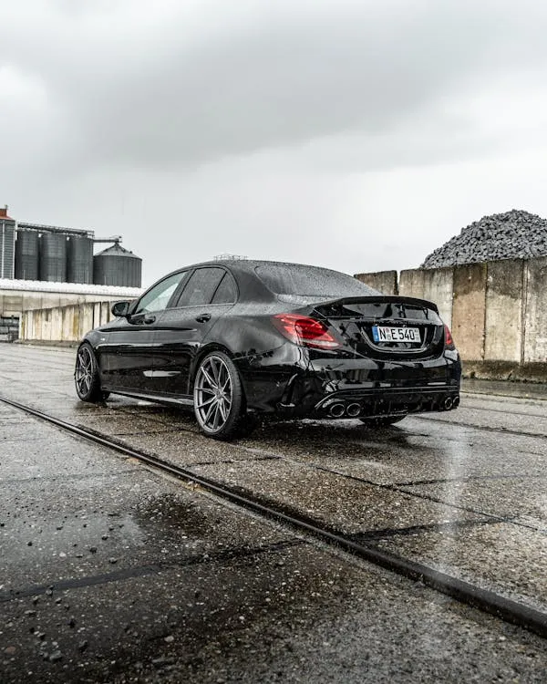Mercedes Benz Sedan Parked on Wet Urban Pavement Wallpaper